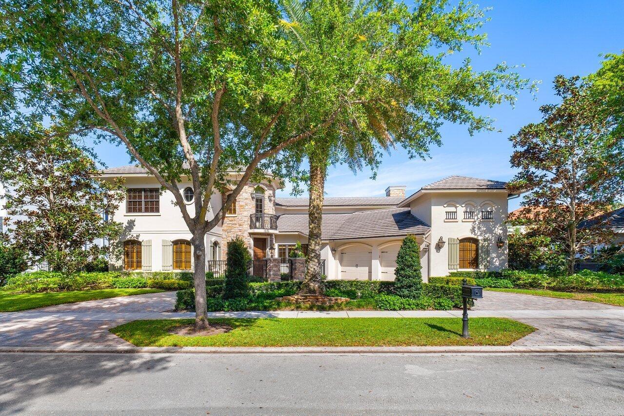 Welcome to this custom lakefront home, perfectly nestled in the highly coveted Hamptons subdivision of Woodfield Country Club. This four bedroom, plus bonus room, five bedroom bathroom residence exudes incredible curb appeal, showcasing a charming stone facade, arched windows, and a wide lakefront lot that offers sweeping water views. The property blends timeless elegance with a relaxed sophistiscation. As you arrive, a circular driveway gracefully leads you to the entrance, setting the stage for the home's breathtaking interior. Step inside to 4,070 square feet of thoughtfully designed living space, where impact windows flood the interior with natural light. The combination of wood and marble flooring, along with graceful arched doorways, adds a touch of elegance.The heart of this
