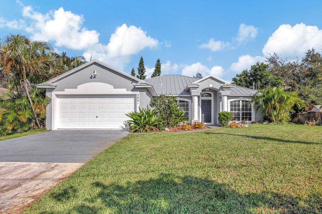 Photo of 2091 SW Bellevue Avenue, Port Saint Lucie, FL 34953 (MLS # R11029327)
