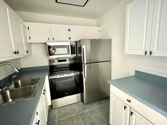 This fully updated one-bedroom, one-bath unit is located in the 55+ Community of Century Village, situated on the second floor. It boasts numerous updates such as new flooring, a tiled bathroom, a new vanity, and new appliances. The community features a very active clubhouse complete with a theater, exercise rooms, and shows. It's conveniently located near shopping and dining areas.