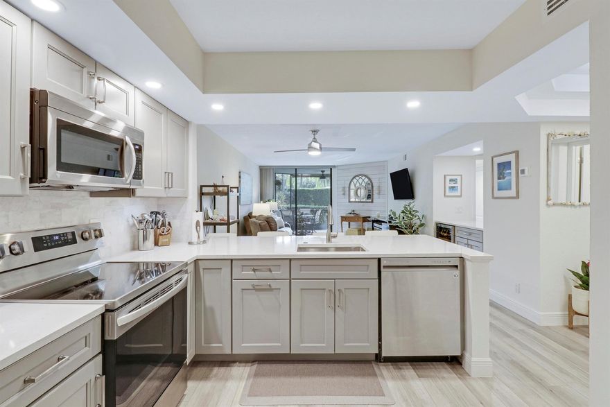 Stunning, Fully Remodeled 2 bed/2 bath ground floor condo in the Resort Community of Bay Colony! Light & bright with an open floor plan, plantation shutters, & vinyl wood flooring throughout. The kitchen features stainless appliances, quartz countertops, & soft close cabinets. The bathrooms have been tastefully updated with walk in tile showers, frameless glass doors, quartz countertops, etc. The private, fully screened & enclosed patio was replaced in 2022 & is the perfect spot to watch the sunset! Bay Colony has 2 marinas, a salt water pool, hot tub, gym, clubhouse, tennis, pickleball, bocce ball & much more. This is all in addition to its central location; being minutes to famous Juno Beach & pier, restaurants & shopping. Tenant occupied until 5/31/2026