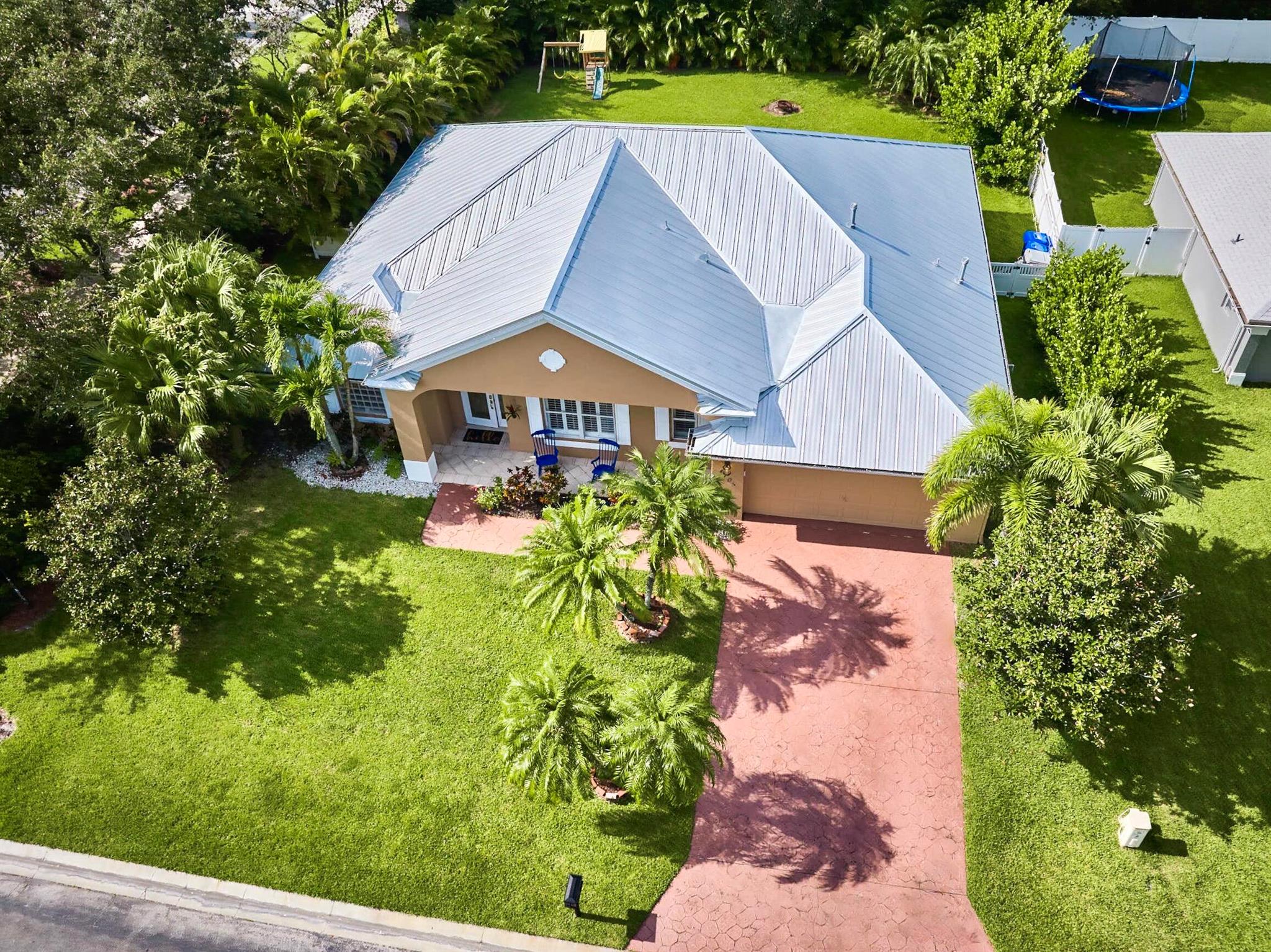 BEAUTIFUL LEGEND LAKES HOME! 2025 exterior painted, 2022 metal roof, 2020 AC. Grand open living/dining/brkfast areas, vol ceiling, stately columns, elegant tray details, arched openings, +plantation shutters thru-out. KITCHEN boasts gas cooking, SS appl's, pantry, brkfast bar. INDOOR LAUNDRYRM includes bonus space--ideal for a 2nd pantry or desk/workspace. Split FlrPlan: BEDRMSUITE w/ 2 walk-in closets, ensuite bathrm, +direct patio access. GUEST WING features 2 bedrms +cabana bathrm--perfectly setup for a future pool build. Covr'd, scrn'd patio overlooks large fenced backyard bordered by lush Areca palms for added privacy. LOC: Mins to ISLAND beaches, parks, museums, galleries, boutique shopping & dining. MAINLAND: big-box shopping, dining, medical, cultural attractions. MUST SEE VIDEO!