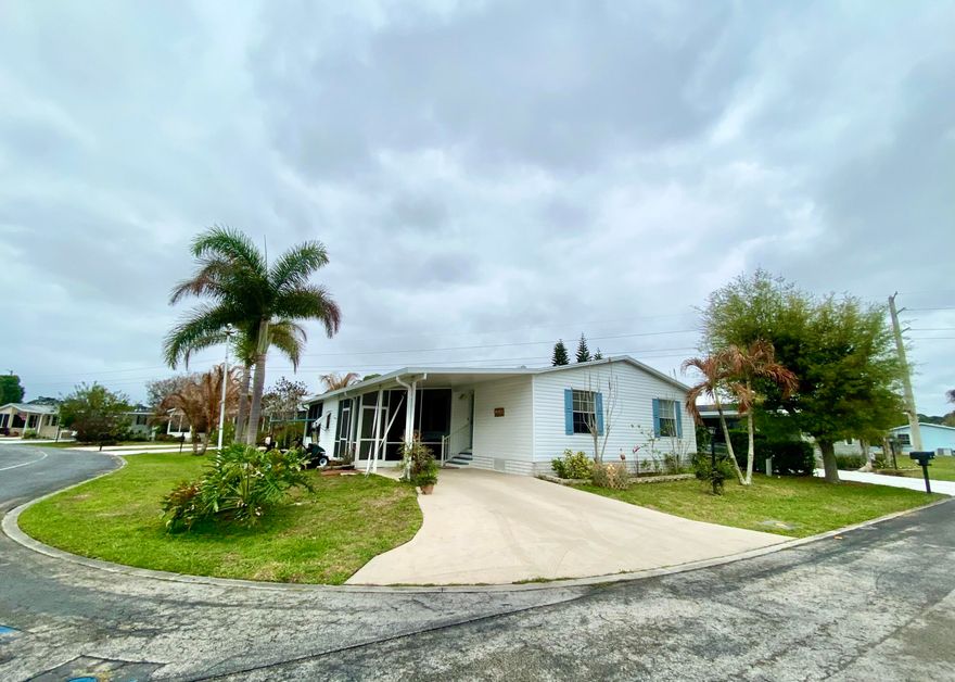 Beautifully maintained 2005 manufactured home, 3/2 with brand new LVP flooring, partially furnished and comes with a golf cart!  Newly added hurricane-rated screened lanai with vinyl windows offers a quiet retreat, located on a corner lot with a longer driveway.  Split floor plan allows guests added privacy.  Laundry room has additional pantry for more storage.  Large master bedroom with walk-in closet and beautiful en-suite bathroom.  Hurricane protection all around the house included.  This community has two clubhouses, two pools located on lakes, and surrounded by a nature preserve, quiet and tucked back off of US-1, private and quiet for you.   AC 2020, Roof 2016, Washer & Dryer 2021, Lanai 2019