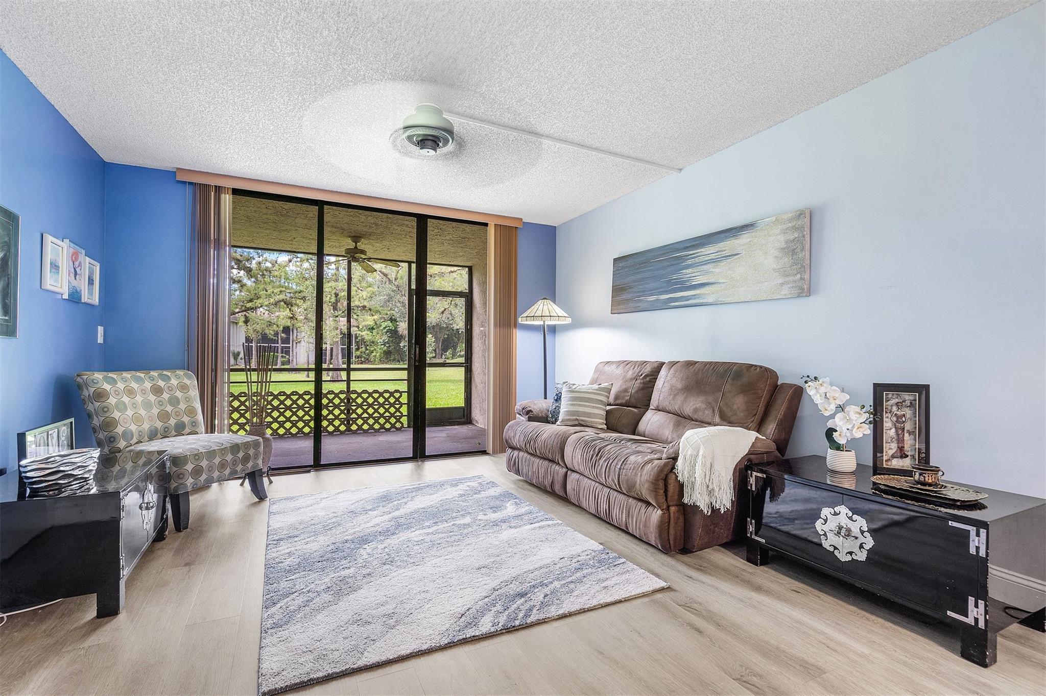 WHY RENT WHEN YOU CAN OWN FOR LESS!! This in-demand first floor 2 bdr 2 ba condo is priced for a quick sale, and even comes partially furnished! Enjoy luxury vinyl flooring throughout the main living areas and take in beautifully landscaped views the moment you walk through the door. Enjoy dining al fresco, or simply relax in your own tropical oasis. Located in the prestigious gated Woodmont Country Club, you'll have access to a well maintained community pool and amenities such as golf courses, tennis courts and a brand new clubhouse. Assigned parking, with plenty of guest spaces. This is an all ages, pet friendly community, close to fine dining, shops, schools, hospital, and highways. You won't find a better value in the community where luxury and affordability meet!