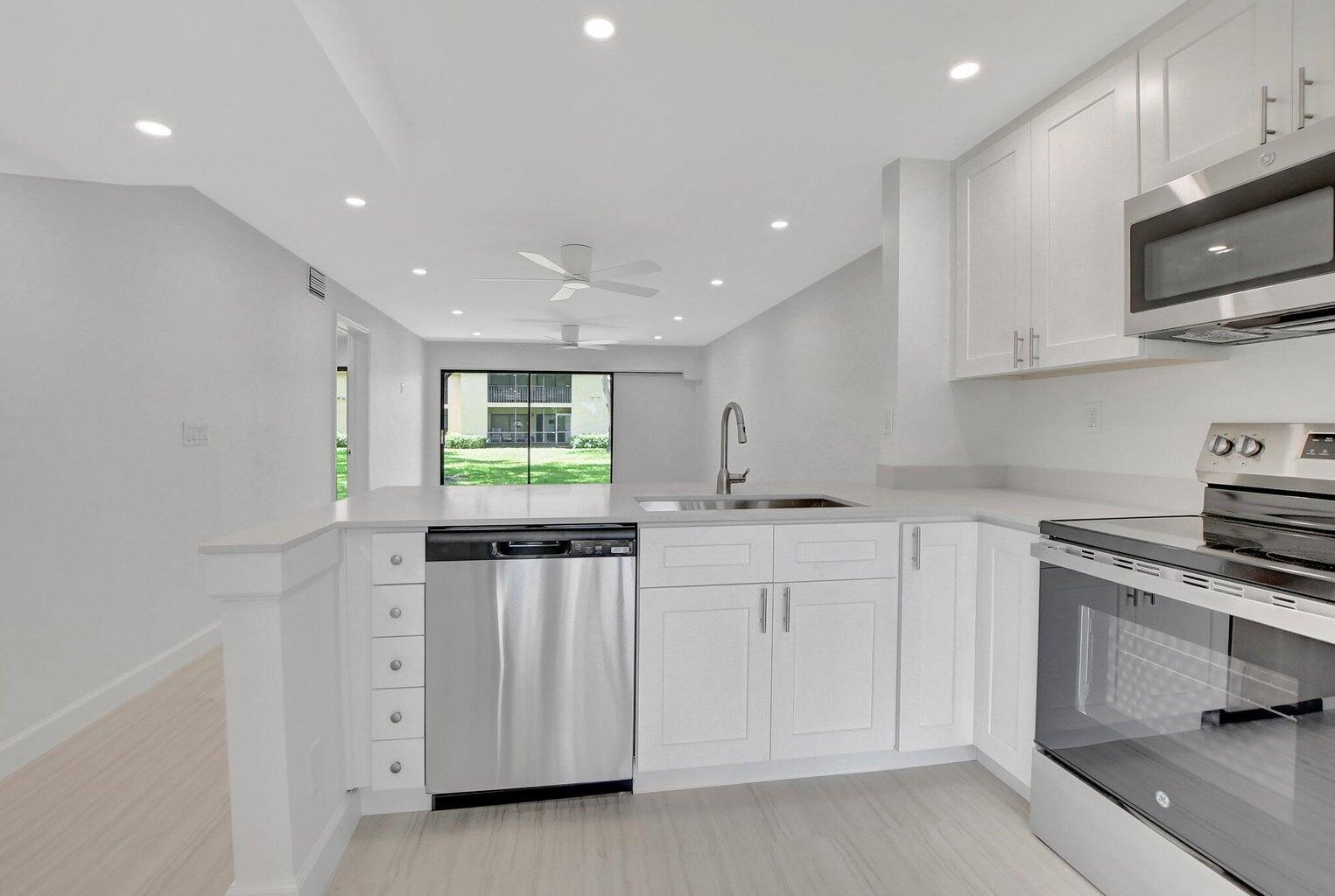 Step into coastal comfort with this fully renovated, ground-floor 2-bedroom, 2-bath East Boca Raton condo. This modern residence features a sleek kitchen outfitted with quartzite countertops, crisp white cabinetry, and stainless-steel appliances. Throughout the home, you'll find elegant porcelain tile flooring, recessed lighting, and custom closet systems. Both bathrooms have been updated with contemporary vanities, stylish lighting, and new plumbing fixtures. Additional updates include a 2024 washer and dryer, and A/C system. Unwind on your private screened-in patio and catch easterly breezes--perfect for relaxing after a day at the beach. Sanctuary Pines is within close proximity to the ocean, shops and restaurants. Residents enjoy access to the community pool and tennis courts.
