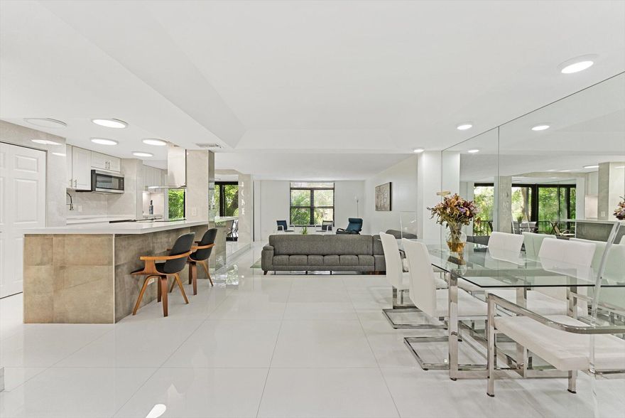 Beautifully reimagined corner unit in a prestigious waterfront community, offering sweeping water views and exquisite designer finishes throughout. Featuring sleek 60x60 porcelain floors, a show-stopping open kitchen with high-end touches, and stunningly upgraded baths. Hurricane-impact windows add comfort and security. Enjoy resort-style living with access to a luxurious clubhouse and top-tier amenities. Just 20 minutes from the beach and minutes to highways, fine dining, shopping, and more--this turnkey home blends elegance, location, and lifestyle.