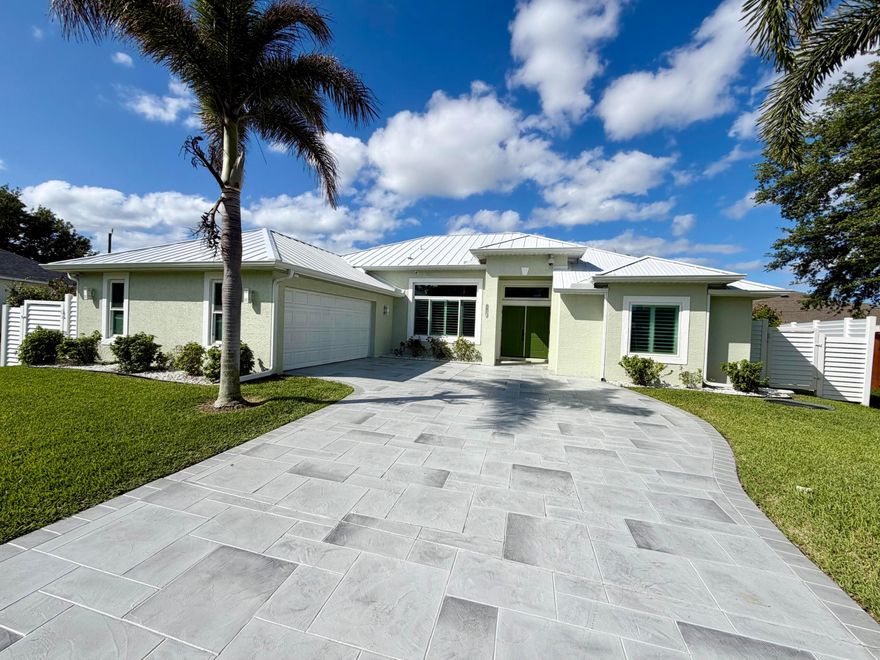Move-in ready pool home with major improvements already completed. Features include a new metal roof (2024), impact windows & doors accordion shutter covered lanai, fresh exterior paint, new gutters, & updated irrigation with well pump. 19,514 sq ft lot has been regraded, sodded, & professionally landscaped with mature trees & privacy fencing. New tile in primary & guest bedrooms. Enjoy a recently screened, heated pool with resurfaced deck and driveway, plus a variable speed pool pump and filter. The lanai offers an outdoor kitchen with Kenyon electric grill. Inside features plantation shutters, updated lighting, & LED bulbs. Addtl upgrades incl a 16-camera security system, solar attic fan, & drainage improvements. Becker Road area with EZ access to I-95 & Turnpike.  Room for RV or boat  Improvements made to Kalevala since Feb 2021: 2021  • New Pool enclosure  • New Fence  • Regrade and sod entire property   • New irrigation system  • New landscaping and new trees  • House exterior paint  • New gutters whole house  • 16 camera security system 2022  • Completed fencing with white slatted PVC in front  • New impact windows  • New vertical blinds for sliders  • Accordion shutters (hurricane) for sliders  • Impact windows  • Impact front door and cabana bath  • Pool heater 2023  • Plantation shutters throughout home  • Exterior lighting  • Kenyon electric grill in lanai kitchen  • Interior light fixtures  • Daylight LED bulbs throughout  2024  • New White Metal Roof  • New Solar attic fan with remote  • New irrigation well pump  • New sump pump installed outside pool deck to help move water more efficiently away from pool deck during large rain events  • Pool deck and driveway resurfaced 2025  • Energy efficient Variable speed pool pump  • Pool filter
