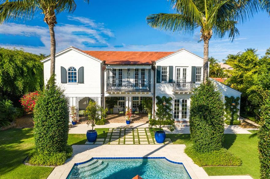 270 Queens marries the charm of classical architecture with the modern conveniences desired by today's discerning buyers, on a rarely found double lot offering expansive grounds and extraordinary outdoor living spaces.
Built in 1940, this stately home was designed by the Palm Beach architect Howard Major, a passionate advocate of classical American residential building design. The home offers numerous gracious living spaces, including a formal dining room, living room, library and kitchen/family room.   The property  was lovingly restored, rebuilt and expanded to the highest standards by local builder Tim Givens.   Many modern features were added including an elevator, impact glass, new red oak floors and all new mechanical systems. At the same time a guest cottage, second garage and large swimming pool were constructed.   The main house offers five bedrooms with en suite baths;  master suite has large marble his and her baths and walk in closets.  The second garage has a lift to accommodate up to three cars with an entrance onto Colonial Lane, in addition to the two car garage attached to the main house.