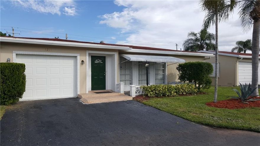 PRICE REDUCED! This popular 2 bedroom 2 bath Granada model home has had some very nice updates done to it. Both bathrooms and the kitchen have had some updating. Custom built shelving in all the closets. Beautiful ceramic tile flooring in the living room & family room & also in the screened in Florida room. Newer A/C! Solar heated hot water tank. Monthly maintenance fee includes the Pool/Clubhouse, exercise room, lawn cutting, cable & painting of your home every 5 years.