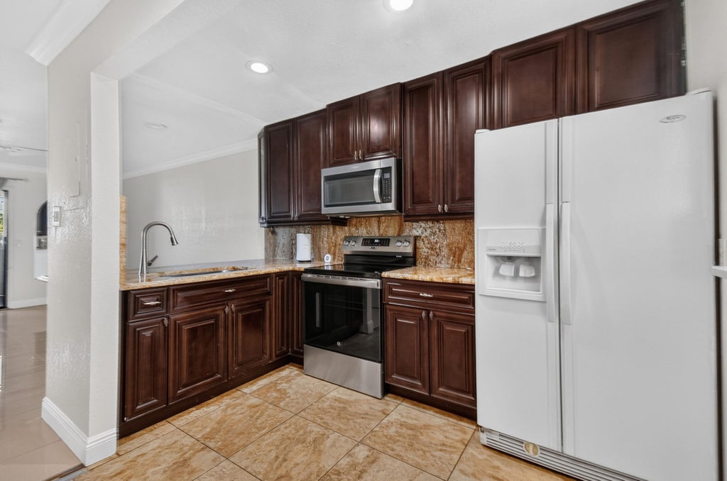 Photo of 617 IXORIA Avenue #23, Fort Pierce, FL 34982 (MLS # B26077123)
