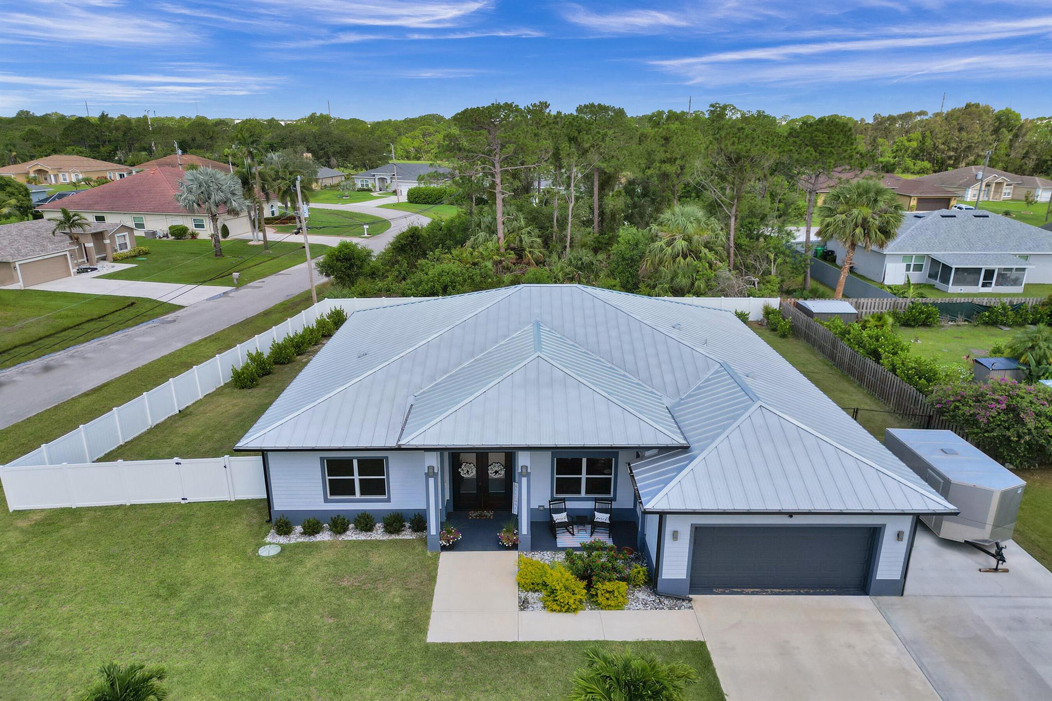 This stunning newer construction 4-bedroom, 3-bathroom pool home sits on a premium oversized corner lot with no HOA fees or restrictions, offering the ultimate in versatility and luxury living. From the moment you arrive, you're greeted by the perfect blend of modern sophistication and traditional charm as the double glass entry doors make a bold statement, while a cozy front porch invites you to relax. Inside, a grand foyer leads to an expansive open layout with soaring volume ceilings, recessed lighting and elegant finishes throughout. Architectural details like tray and coffered ceilings, a contemporary color palette and sleek zebra shades add both style and functionality to the space. The upgraded chef's kitchen is a showstopper with custom cabinetry, black quartz countertops,