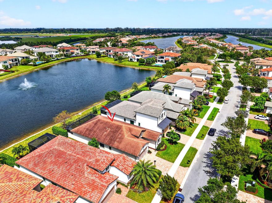 Built in 2018 within a gated community, this single-story home blends style and function. Enjoy a fenced yard and an oversized pavered, screened patio—perfect for outdoor living. Inside features 25" tile throughout and striking glass double front doors. The chef's kitchen offers two-tone cabinetry with glass accents, granite and quartz counters, subway backsplash, soft-close drawers, a 5-burner gas stove, double oven, and hidden pantry. The primary suite boasts dual sinks, two closets, a soaking tub, separate shower, and floor-to-ceiling tile and mirrors. Amenities include pool, kids splash zone, pickelball, tennis, indoor sport court, tot lot and fitness center. Impact glass, epoxy garage with EV charger, mud room, and laundry tub complete this stunning home.