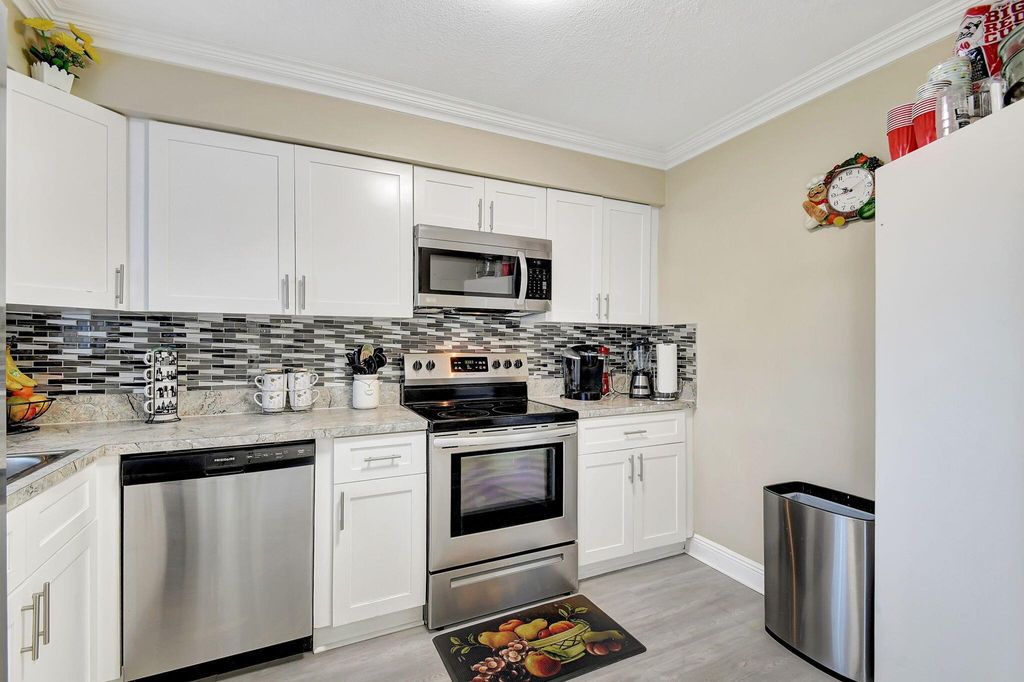 Photo of 3003 Poolside Drive, Greenacres, FL 33463 (MLS # R11126878)