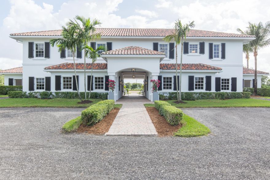 Prime property positioned in Palm Beach Point East, this 5-acre equestrian estate has recently undergone a thorough renovation. This property enjoys direct land access to the bridle path that leads to WEF, which is just a short hack away. This well-appointed 18-stall barn includes two offices each with a kitchenette, half-bath, and attached tack rooms, two laundry rooms with built-in storage, a one-bedroom grooms' apartment with kitchenette, and a storage room with built-in cabinetry. The second level of the building houses two separate living quarters, both an owners' apartment and an additional grooms' apartment; each of which includes two bedrooms and two bathrooms. The grounds of the property include a Riso fiber arena, 10 paddocks, and a spacious storage garage.