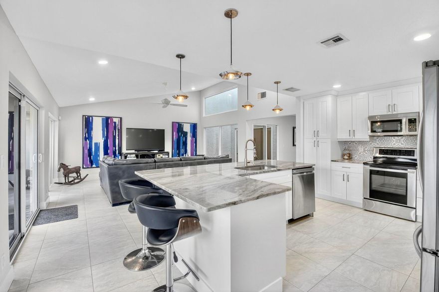 Beautifully and thoughtfully renovated 3/2 home offering modern updates and inviting living spaces. Located in desirable Woodlake community: all-ages, pet-friendly, very low HOA. This move-in-ready property features a spacious open-concept layout filled with natural light and a charming atrium that creates a bright and airy atmosphere. Major upgrades provide peace of mind, including Hurricane Impact windows and doors, updated electrical panel and wiring, insulation, plumbing, full water purification system, gutters, pavers, and security system. Roof 2018,  AC 2019. Step outside to a large private backyard perfect for relaxing or entertaining, complete with a hot tub and lush landscaping featuring fragrant sweet almond and blackbead, bay leaf and local cedar trees. Just minutes from vibrant Downtown Delray Beach, Atlantic Ave dining and shopping, and its beaches.