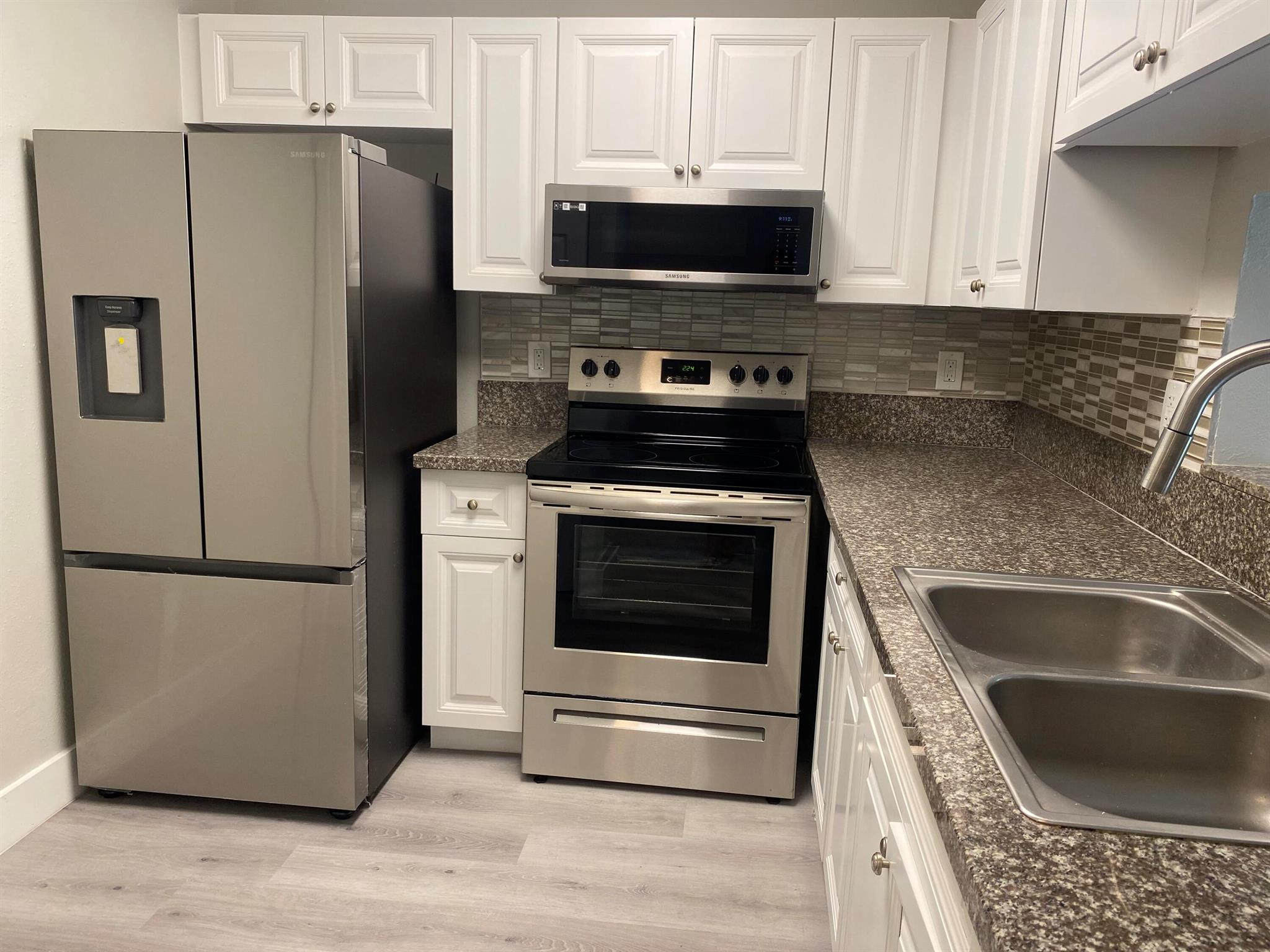 COMPLETELY UPDATED AND MODERN! This immaculate 3 bedroom / 2 bathroom unit is ready for immediate move in! This first floor unit will wow you the moment you enter. Everything has been renovated. New kitchen appliances, granite countertops, backsplash, laminate floors, vanities, light fixtures, fans, window treatments, freshly painted, new private washer and dryer in storage unit on patio and so much more. Fast approval process. Don't miss your opportunity. Call now. Close to all shopping, supermarkets, parks, schools and major highways.