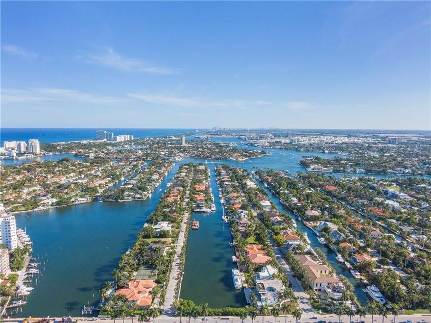 275' of deep waterfront takes center stage at this lushly landscaped tropical compound. This 33,000 sq ft lot with expansive waterway views in the Las Olas Isles is designed for boating. Resort style outdoor entertaining area complete with a pool, spa, summer kitchen, wet bar, oversized tiki pavilion & dining area. The sprawling side lot provides a rare opportunity to expand & build on simply enjoy the green space. The elegant interior is introduced from a vine covered porte-cochere that opens to a 2 story grand foyer with a graceful stairway & great rm with wet bar. The gourmet kitchen opens onto a 2 story dining rm & family rm. The 1st floor master suite offers a sitting area, lavish bathrm & 3 walk-in closets. Mother-in-law suite or staff qtrs. & 2nd floor loft area. Sq ft from IMAPP.