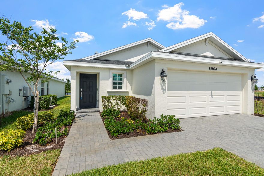 Not like the others! This 2023 Annapolis Model is priced to sell, has more upgrades, and best of all a water view and on landscape barrier! Pulling into the paver driveway, you are protected by an exterior voiced camera system and full impact windows (no panels). Inside you welcomed by neutral colors throughout and white shaker cabinets with quartz counter tops.  A gas stove with barely used, matching GE stainless steel appliances compliment the kitchen perfectly. Recessed lighting and designer fans and fixtures were carefully selected. The main bathroom suite added a seamless glass door and rain shower head. In the laundry room, the Samsung "Flex Wash" units allow for two loads to be ran separately. Out back, both a covered lanai and extended screened patio offers the perfect spot for  sunsets and wildlife watching. The landscape buffer on one side of the home will offer extra privacy once finished. Be sure to see this home today!