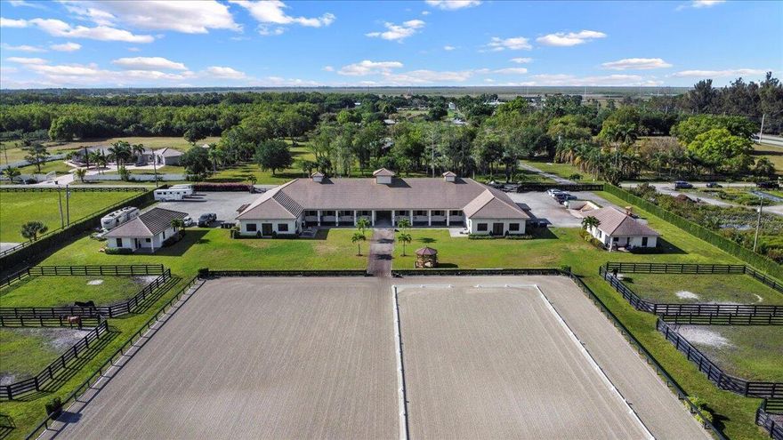 Located just a short drive to Wellington's horse showgrounds, this luxurious barn, built in 2017, is available for rent and is in impeccable condition. Situated conveniently on a paved road, the property offers 4 to 8+ stalls, shared access to premium amenities including an air-conditioned tack room, feed room, laundry facilities, a half bath, wash racks and 8 paddocks. The property is fully fenced with an automatic gate for security and ease of access, ample parking and shared use of a generously sized arena (250' x 180') with a covered viewing area. Additionally, this remarkable property also has 2 camper hookup spots for added convenience. Surrounded by gorgeous palm trees and lush landscaping, the barn offers a picturesque ambiance. The landlord will accept  Dressage or H/J tenants.
