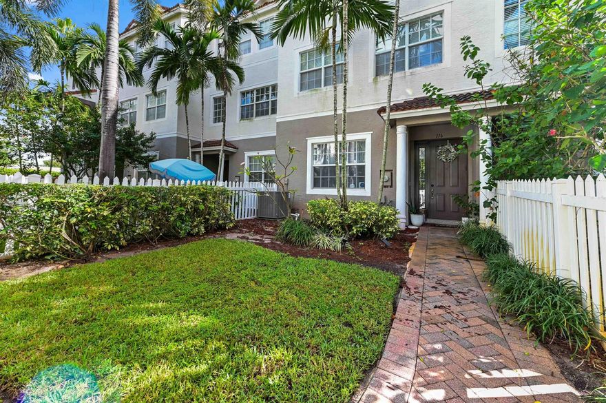 Welcome to this stunning three-story intracoastal townhome in Ocean Cay, where modern comfort and a vibrant community lifestyle converge. The community offers a picturesque entrance with a white picket fence and a charming hedge-covered archway, leading down a brick-paver walkway framed by towering palm trees. The exterior features a classic Florida Mediterranean style with private attached two car garage.
