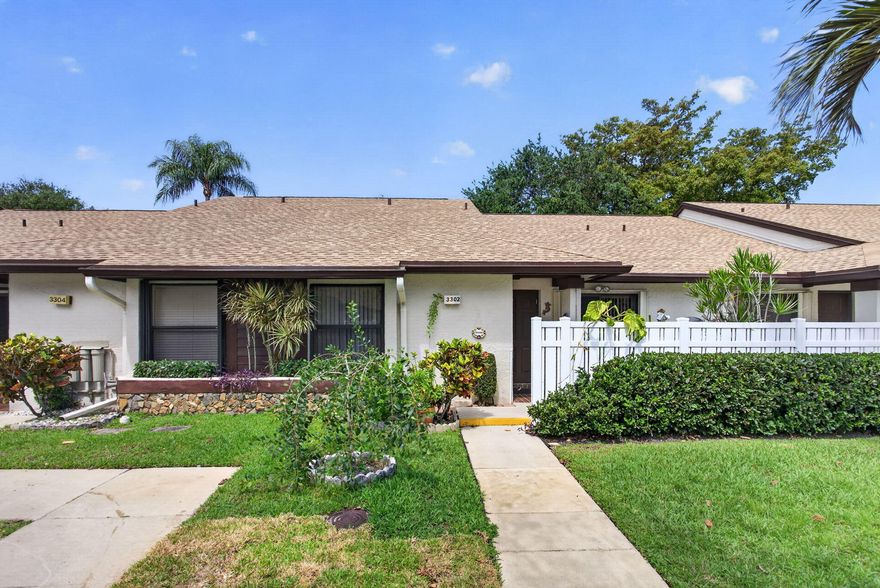 This exceptional 2-bedroom, 2-bath residence is completely move in ready and thoughtfully designed for modern living. The bright, open split floor plan features a spacious primary suite with a large walk-in closet and private access to the enclosed Florida room which offers a large storage closet. The living area also opens directly to this versatile, air-conditioned space, perfect as a den, lounge, or even a third bedroom all while showcasing serene water and greenery views. Sun Guard screens and tinted sliders offer protection from the heat and privacy.   Inside, you'll find vaulted ceilings, elegant wood flooring, recessed lighting, and crown molding that elevate the home style. The kitchen and bathrooms are tastefully updated with wood cabinetry, granite countertops, and Italian ceramic tile. Both bathrooms offer modern finishes and pocket doors providing an en-suite experience. Stainless steel kitchen appliances are just 2 years.   Packed with upgrades: impact front door and bedroom window, accordion shutters (2018), surge protected electrical panel, remote controlled ceiling fans, and outdoor floodlight with auto sensor, plus all permits in place. Major improvements include a brand-new roof with wind mitigation (2025), A/C (2018), water heater (2017), and nearly new washer and dryer.  Step outside to enjoy two private patios front and back perfect for entertaining, relaxing, or soaking in the tranquil waterfront setting. Ideally located near shopping, schools, major highways, and everyday conveniences.  Quarterly HOA is $2,150 (includes roof loan) plus $189 master association. Cable included, with internet coming soon.  This is the kind of home buyers get excited about, don't miss the opportunity to see it in person!