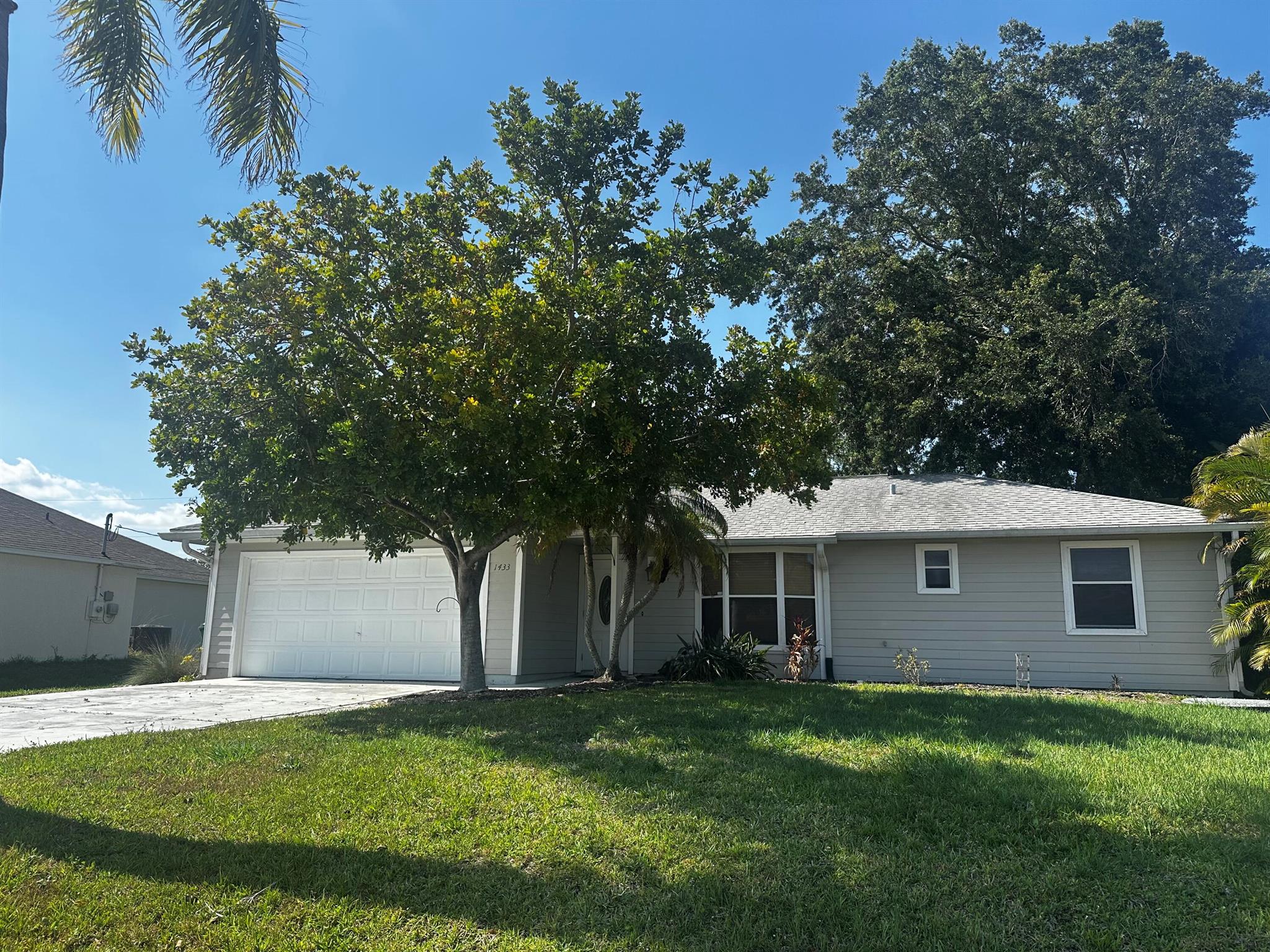 THIS SINGLE FAMILY HOME IS CONSTRUCTED WITH CONCRETE HARDY PLANK AND LOCATED IN A QUIET AREA OF PORT ST LUCIE. NO HOME OWNER ASSOCIATION AND ALL NEIGHBORS MAINTAIN BEAUTIFULLY LANDSCAPED HOMES. THIS SPLIT PLAN HAS CERAMIC TILE IN THE LIVING AREA AND CARPET IN THE BEDROOMS. THE SCREENED PATIO IS PERFECT FOR OUTDOOR EVENTS WITH GUESTS OR LARGE FAMILY EVENTS. THE TWO CAR GARAGE HAS ROOM FOR 4 VEHICLES ON THE DRIVEWAY. THERE IS A VACANT LOT BEHIND THE HOME FOR PRIVACY IN THE BACK YARD.ROOF WAS REPLACED IN 2004. PUBLIC AND PRIVATE SCHOOLS NEARBY AND BUS SERVICE AVAILABLE. VACANT READY FOR THE NEW OWNER!!