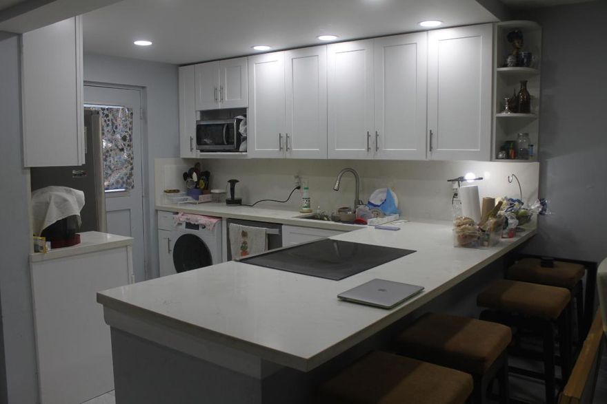 Step into this renovated 2 bedroom, 2 bathroom ground-floor condo. The updated open kitchen features stunning quartz countertops. Ample closet space and roll-down shutters on windows and patio.