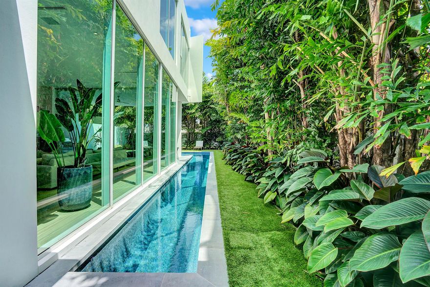 Indulge in the pinnacle of luxury living in this recently completed modern masterpiece! Nestled in the prestigious Palm Trail neighborhood, just two blocks from Atlantic Avenue and a leisurely stroll to the beach, this striking modernist home embodies sophistication at every turn.Crafted by the esteemed Azure Development and renowned architect Jeffrey Silberstein, this two-story sanctuary spans 3,982 square feet under air, boasting a total of 5,090 square feet. Revel in 4 bedrooms,4 and a half baths, a spacious club room, an oversized two-car garage, and an exclusive gated motor court entrance. Step into your private oasis with a sprawling wrap around pool and meticulously landscaped gardens.Experience the epitome of openness and light with 12-foot high floor-to-ceiling glass all around