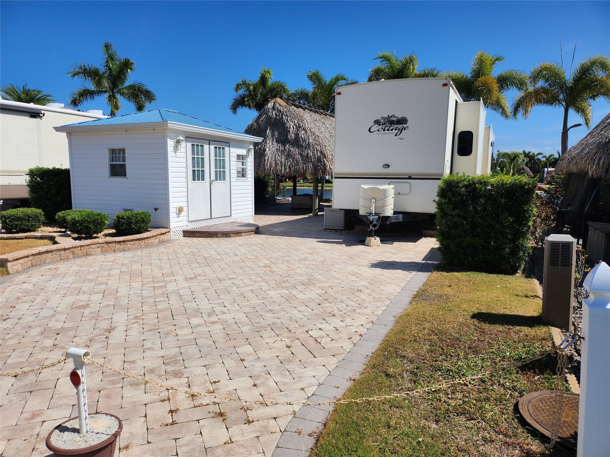AMAZING OPPORTUNITY: ESTATE SALE. LAKE LOT 53. LUXURY SILVER PALMS RV VILLAGE. SPACIOUS BEAUTIFUL LOTS, OWN YOUR LAND, POA FEES, 1500 SF +/-PAVERS, 12'X16' TIKI W ELECT, 12'X10' CASITA W ELECT, FULL SIZE W/D. INCL PATIO FURNITURE, FIRE PIT, COMMUNIY CALENDAR, POOL, SPA, POOL BAR, PRIVATE CLUB ROOM, CLUB HOUSE, ON SITE BATH HOUSES, LIBRARY, GYM, CARD ROOM, PICKLEBALL, DOG PARK. PARADISE IN A COUNTRY SETTING AMIDST WONDERFUL NEIGHBORS, (NEAR BY SHOPPING, DINING AND LOCAL EVENTS, FISHING, HIKING) THE GREAT LAKE OKEECHOBEE AND PIER JUST MINUTES AWAY. RELAXING SUNRISE/SUNSETS .
40' LUXURY TRAVEL TRALER W SLIDEOUTS AVAILABLE ONE OWNER, NEVER "ON ROAD" TRAVEL. IF YOU WERE THINKING, NOW IS THE TIME TO ACT. DUE DILIGENCE CHECK ALL INFORMATION.
