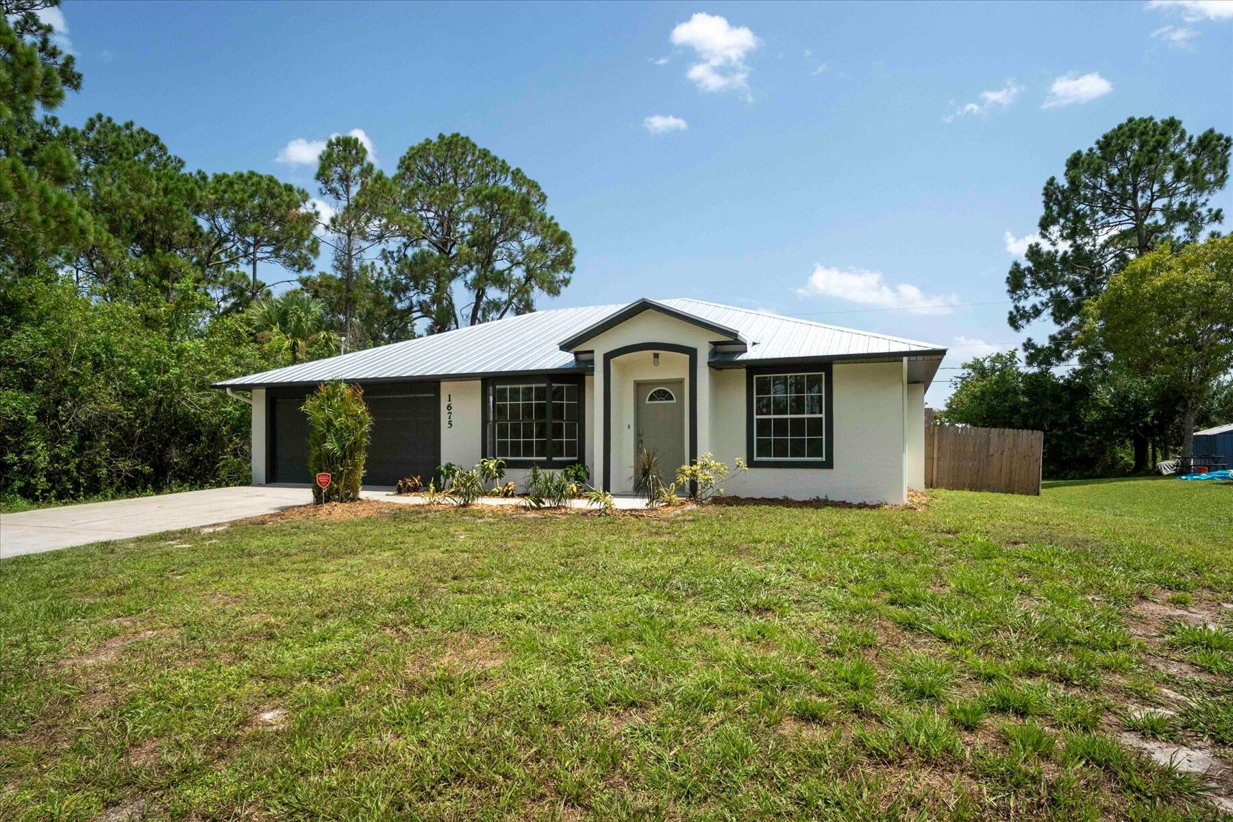 Beautifully remodeled home in 2023 completely move in ready. Offering new quartz kitchen with luxury shaker cabinets and high end finishes, new bathroom vanities and finishes, luxury vinyl floors and new carpet, fresh paint in and out, new fixtures and landscaping. 1738 total sq ft including garage makes the home larger than it reads. Easy access to i95 and Turnpike. Close to all beaches and shopping. Move in ready condition, you wont need to lift a finger. No HOA!! 2023 Metal Roof great for low insurance cost.