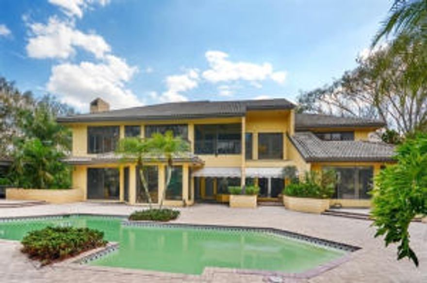 Escape to your very own private Florida oasis in prestigious PALM BEACH POLO, GOLF & COUNTRY CLUB.  Relax with a cup of morning coffee in the peaceful serenity of privacy porches or balconies from every room in this 5 br,6ba, elegant, Contemporary Custom Designed Home, which is an entertainer's delight with flowing floor plan, wood burning fireplace, gorgeous views of the sparkling swimming pool, golf course, gazebo and mature lush tropical landscaping. Gorgeous living room with 25 feet ceiling and coral wall.  Master suite on 1st floor in this 1 owner only home. Amazing oversized cul-de-sac lot featuring private Motor Court and Royal Palm lined Circular Arrival Court. Spectacular welcoming 2 story Foyer with marble flooring. Brand new air conditioning installed in Aug.2015