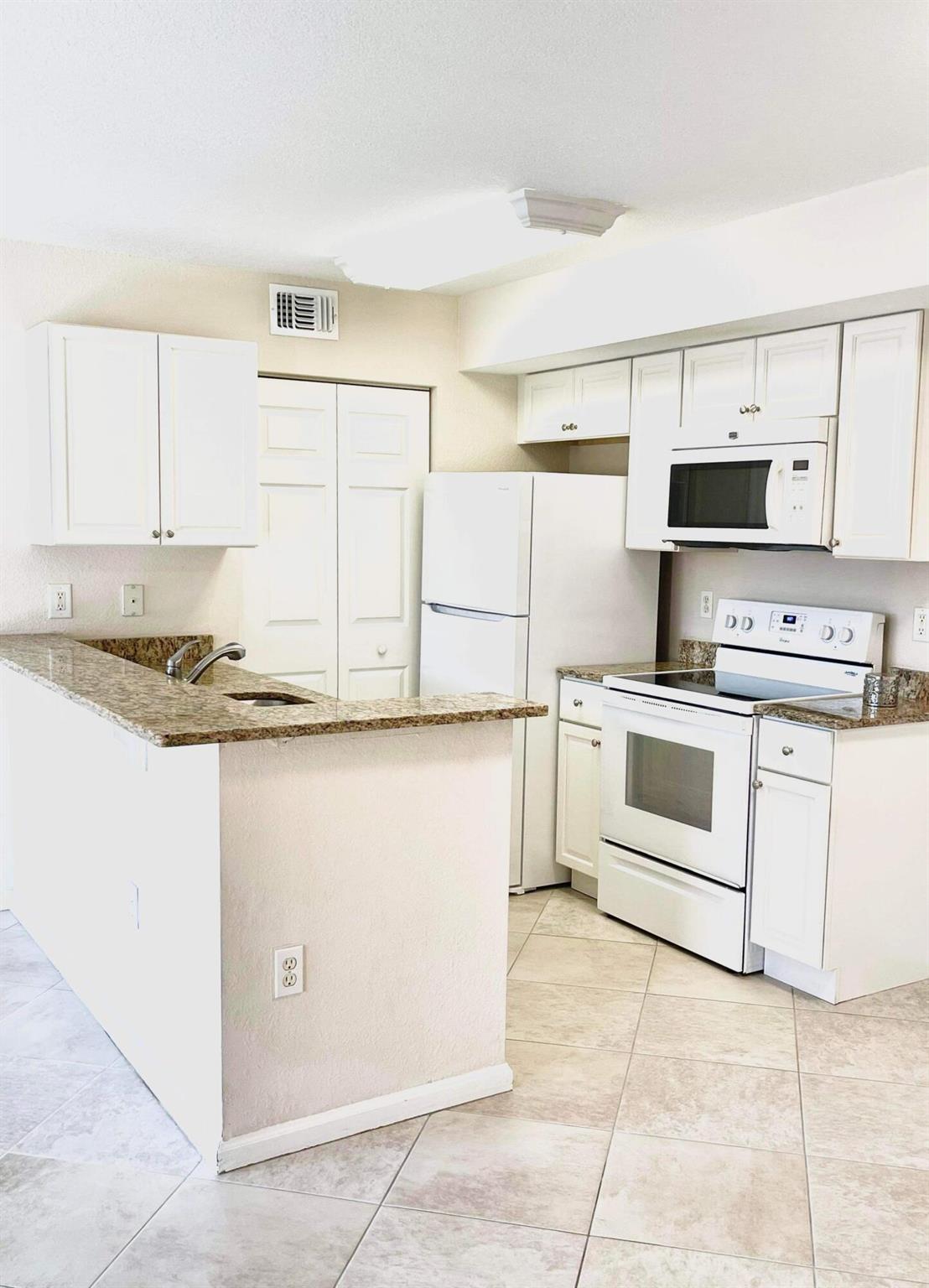 This move-in ready second-floor condo features 2 spacious bedrooms, 2 full baths, tile flooring throughout, and a modern kitchen with granite countertops. Located in The Club, a gated community offering resort-style amenities including a swimming pool, clubhouse, fitness center, tennis courts, business center, BBQ area, and playground.Perfectly situated just minutes from I-95, Florida's Turnpike, top-rated golf courses, and gorgeous ocean beaches. Whether you're looking for a full-time home, seasonal retreat, or investment property, this one has it all.