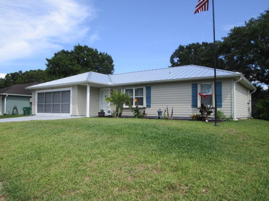 Everything is done. Make this your home sweet home. Perfect for investors, first time home buyers or as a home away from home. New kitchen with lots of cabinet space and large quartz counter island, open floor plan with luxury vinyl flooring, newer metal roof (Dec 2023), remodeled Jacuzzi (brand) guest bath, updated master shower and vanity, quartz counters, sprinkler system, accordion shutters, newer HVAC (2020),  2024 appliances, 2023 washer and dryer, ring camera system, screened patio and an 8x10 (permitted) shed, in a lovely shaded, tropical backyard with room for a pool. This home is located in a quiet neighborhood close to beaches, boating, restaurants, shopping and I-95. Easy to show.  Dog pen does NOT convey. Flag pole does NOT convey.