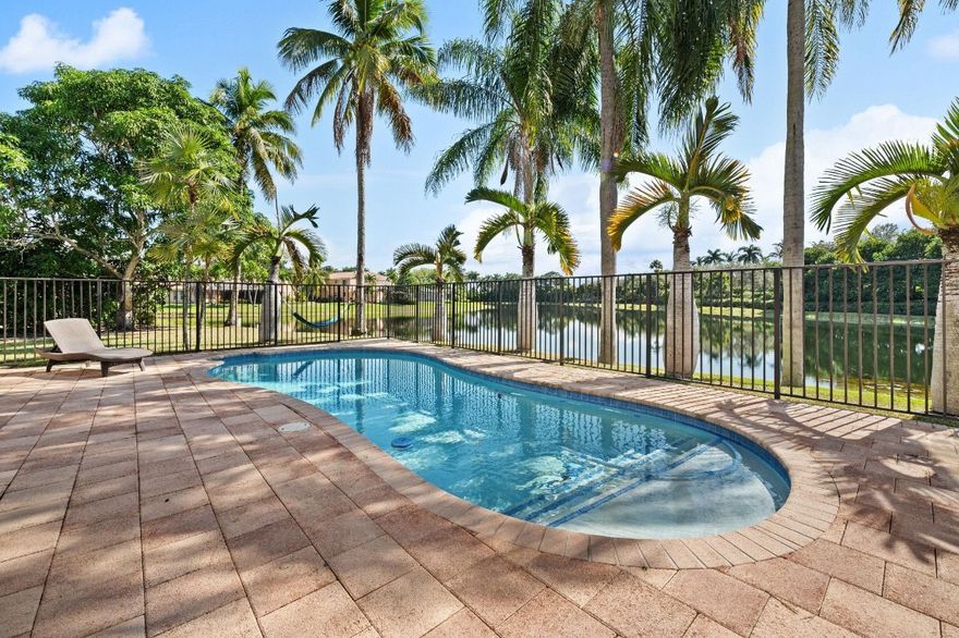 Welcome to this charming waterfront retreat! This delightful home blends the relaxed vibe of a beach house with the warmth of a cottage and the character of a farmhouse.  Bright, open spaces, inviting details, and a cozy, welcoming feel make it the perfect place to call home. This private lakefront pool home is set on the largest cul-de-sac lot in the community, pool recently resurfaced and new tiles. Remodeled kitchen features quartz countertops, GE Stainless Steel appliances & soft close cabinets. Beautiful remodeled main bath, secondary bath & outside cabana bath. Marble and enginered wood floors throughout, solid wood on staircase, 2 Newer HVAC A/C's, Roof replaced in 2012, water heater is 2 years old. Paver drive/walkway and patio. Close to Weston Town Center, Publix Cafes & Schools.