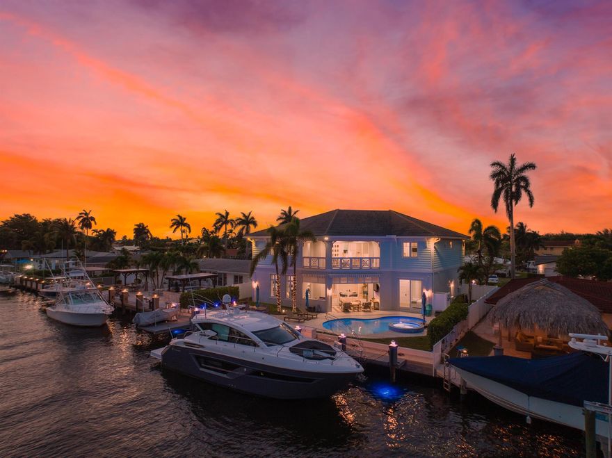 Stunning British West Indies-inspired deepwater estate in the exclusive enclave of Pompano Beach, Florida. Overlooking the Capri Canal, this estate features more than 80 feet of water frontage, offering direct Intracoastal and ocean access, and is only minutes from the Hillsboro Inlet. This home is an epitome of luxury living, encased in luminous glass rooms with breathtaking views of the waterway and a resort-style pool. Engineered with smart home automation, this estate extends its intelligent features to all corners, including the garages. The Chef's Kitchen is a classic blend of chic design and modern amenities, boasting Sub-Zero and Wolf appliances, a gas range with natural gas hookup, and an island breakfast bar. The quartz countertops, full tile backsplash, and