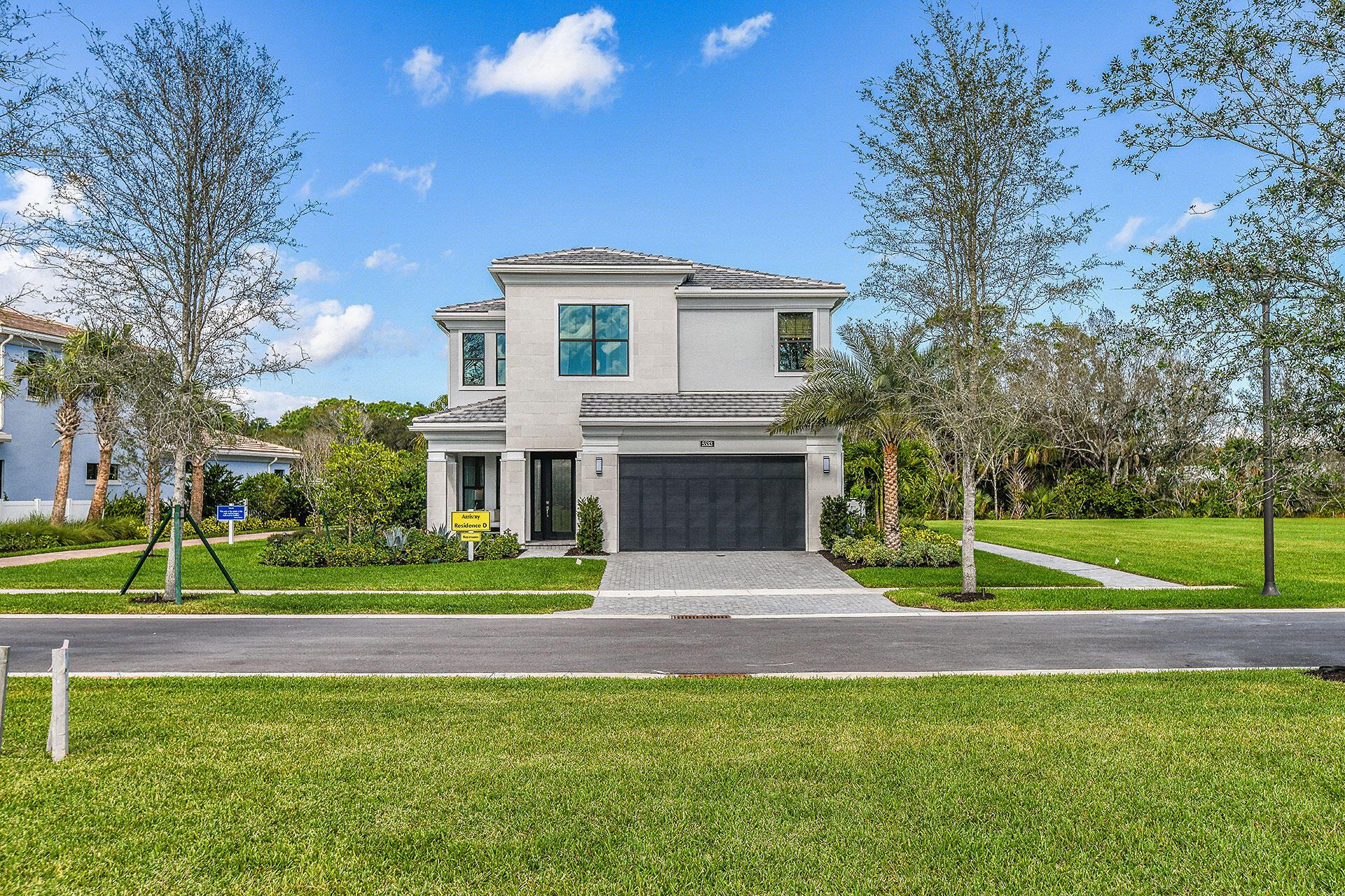 This exceptional decorated model home is a true showcase property located in the private, gated community of Artistry Palm Beach. Fully furnished and professionally designed, this move-in ready residence features 4 Bedrooms, a Den, 3 full Bathrooms, and 1 half Bathroom, with every detail meticulously curated.Upon entry, you're greeted by a grand Living room with large windows and a coffered ceiling, setting the tone for the elegance that awaits. The stairway to the second floor provides the perfect separation to the family room, kitchen, and Dining areas. The rear of the home is accented with triple sliders in the family room and a triple window in the dining area, allowing for bright natural light to fill the space.The island-layout kitchen is designed for relaxed entertainment,