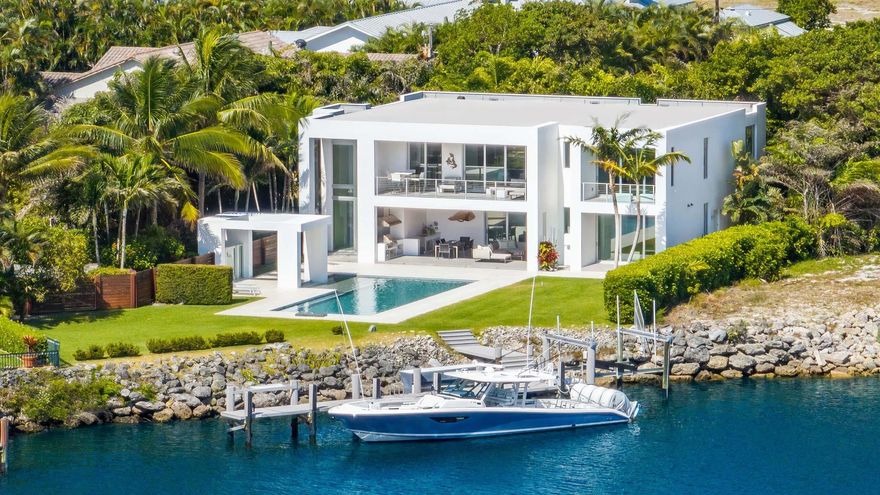 Welcome to this custom modern masterpiece designed by a local award-winning architect. Boasting 95 feet of no-wake zone waterfrontage offering unobstructed water views even with a yacht in residence. The long driveway ensures privacy and creates a compound-like exclusivity. Other features include a primary wing with private balcony; three additional large bedrooms; gourmet kitchen with walk-in pantry; expansive private backyard with 45-foot lap pool; deep covered balconies and loggia spaces; summer kitchen; Control4 home automation system; and whole house generator. This home was built for serene privacy yet has lots of space to entertain beautifully. Situated close to the shops and restaurants in Delray Beach and Boca Raton, this stunning waterfront estate offers luxe living at its best!
