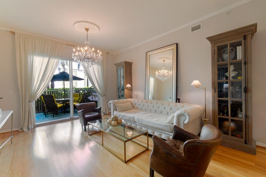 COASTAL CHIC MEETS MODERN COMFORT! Step into this TERRIFIC 2-BEDROOM FIRST-FLOOR CONDO, where style and practicality blend seamlessly. Your PRIVATE PATIO opens directly to the sparkling community pool - ideal for entertaining or savoring tranquil outdoor moments. Convenient assigned parking spot in the building garage. Condo has bamboo flooring, higher 10' ceilings, and newer appliances, including air conditioner and water heater - everything you need for convenience. Kitchen updates include epoxy countertops and floor. Beautifully renovated master bathroom featuring a beautiful walk in tile and glass shower, a stylish vanity, an LED-lit mirror, extra storage, and a bidet toilet. Both bedrooms have walk-in closets. Some furniture is included. Resort style Moorings on the Intracoastal  has two pools, hot tubs, and dry saunas. The clubhouse has been freshly updated. Well-equipped gym overlooking over the marina. 24 hour security, valet, and Malbec and More restaurant.