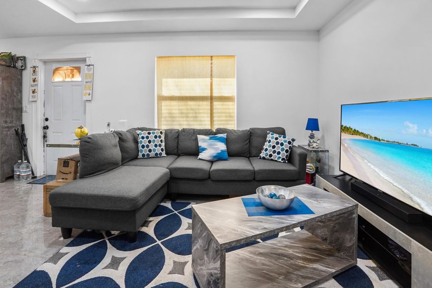 Experience a masterclass in modern versatility of this beautiful retreat nestled in the heart of Basswood Estates. This unique property sits on an expansive 0.36-acre lot, where mature shade trees frame a charming light-blue stucco exterior. The innovative split-level design offers a complete living solution, featuring a private upstairs apartment perfect for multi-generational living or rental potential. This secondary suite includes its own efficient kitchenette, a modern bathroom with a dark wood vanity, and a private covered balcony with a grey-stained wood deck. The main floor is an entertainer's dream, centered around an open-concept living area with sophisticated marble-look tile flooring that flows seamlessly throughout. Look up to find a stunning recessed tray ceiling accented with custom blue LED mood lighting. The kitchen boasts a white quartz countertops, sleek grey cabinetry, a contemporary subway tile backsplash, and high-end stainless steel appliances. Practicality meets style with bathrooms featuring rustic wood-grain vanities.

The outdoor living space transforms this property into a private family playground. The massive, fully-fenced backyard features a built-in geometric play structure and swing set. Extensive practical amenities include a large storage shed for your gear, a covered carport to protect your vehicle, and a spacious paved driveway. Located on a quiet street showing proximity to local airfields and recreation, this home is the ultimate move-in-ready opportunity for buyers seeking both luxury and flexibility.