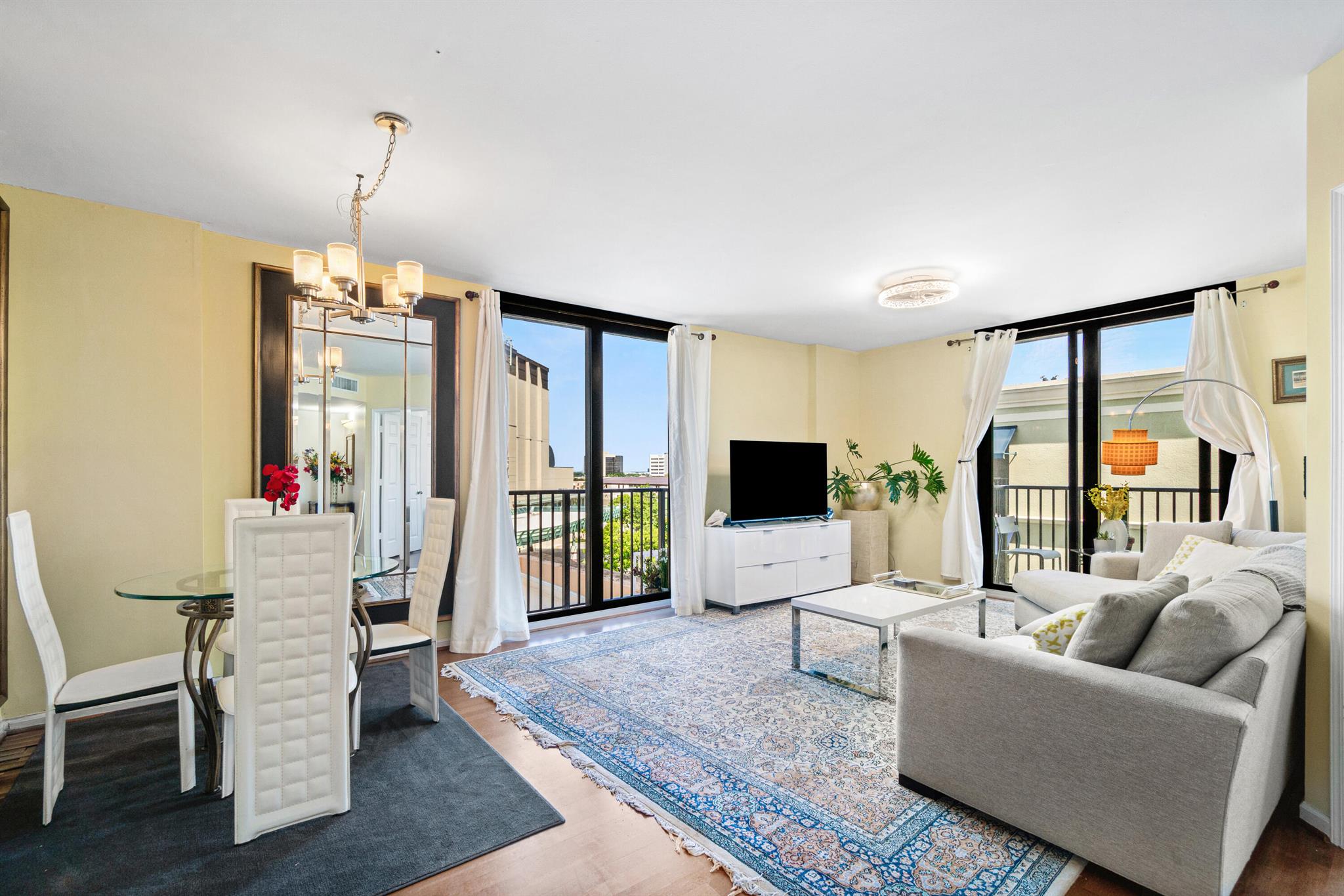 Welcome to 651 Okeechobee Boulevard, Unit 402 in the heart of West Palm Beach. This fully furnished corner residence offers the perfect blend of modern style and urban convenience just steps from Rosemary Square's shops, dining, and entertainment. The open-concept layout is bright and inviting, featuring engineered wood and laminate floors throughout and floor-to-ceiling impact glass doors that fill the space with natural light and showcase peaceful garden and city views. The sleek kitchen is equipped with granite countertops, stainless steel appliances, and custom cabinetry, making it as functional as it is stylish.