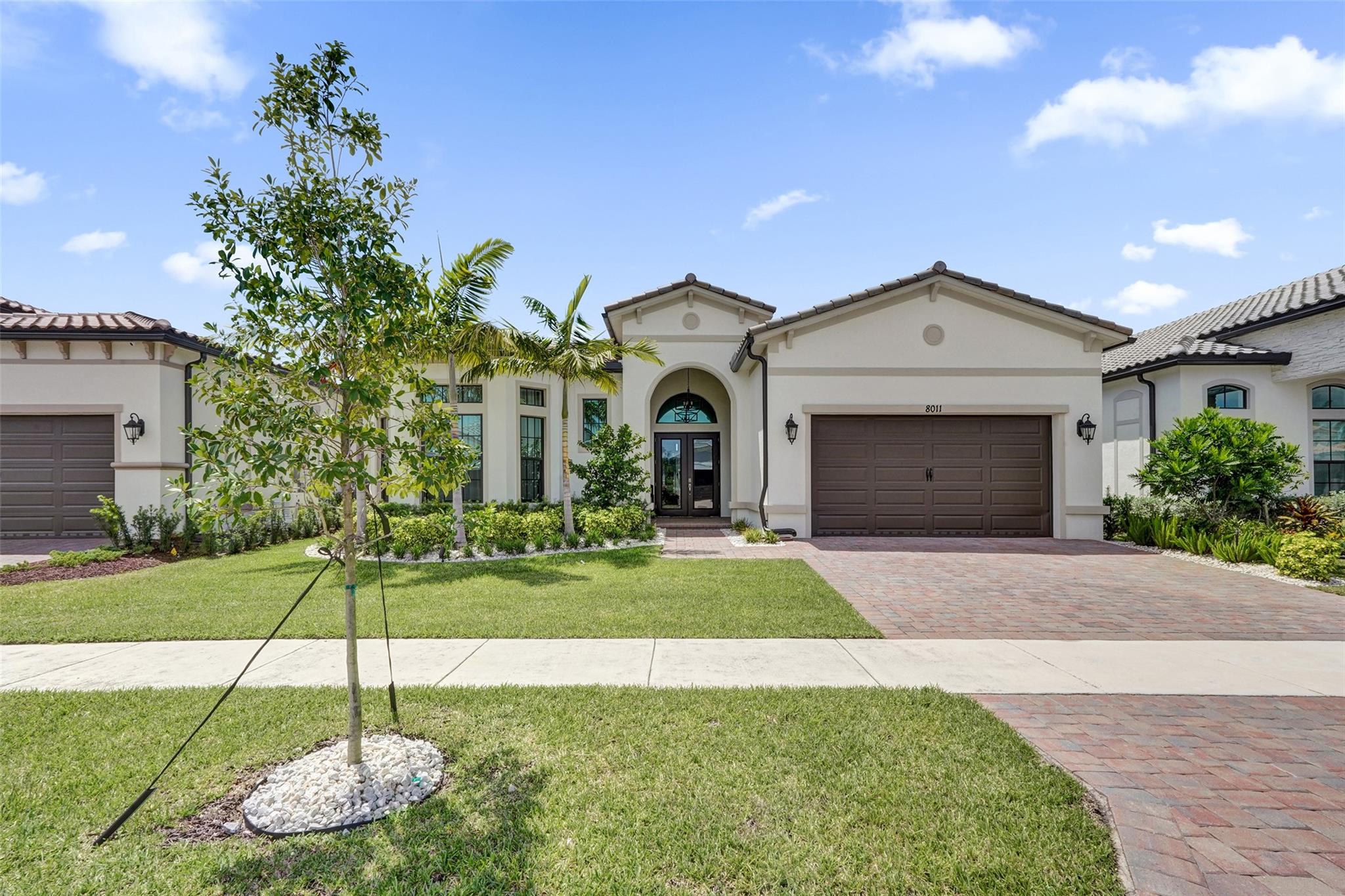 Welcome to this stunning one-story home in the highly sought-after Falls at Parkland. This waterfront residence features 3 bedrooms, 2.5 bathrooms, and a spacious two-car garage. The open kitchen offers granite countertops, a large island, elegant black cabinetry, a pantry, and stainless-steel appliances, including a gas range. Relax on the covered patio with serene lake views and tropical landscaping. Additional highlights include hurricane impact doors and windows, a fenced backyard, and a laundry room with full-sized washer and dryer. The primary bedroom features a walk-in closet and a luxurious bathroom with dual vanities. Enjoy resort-style amenities: clubhouse, fitness center, pool, spa, pickleball courts, theater, card rooms, billiards, ballroom, and an on-site café.