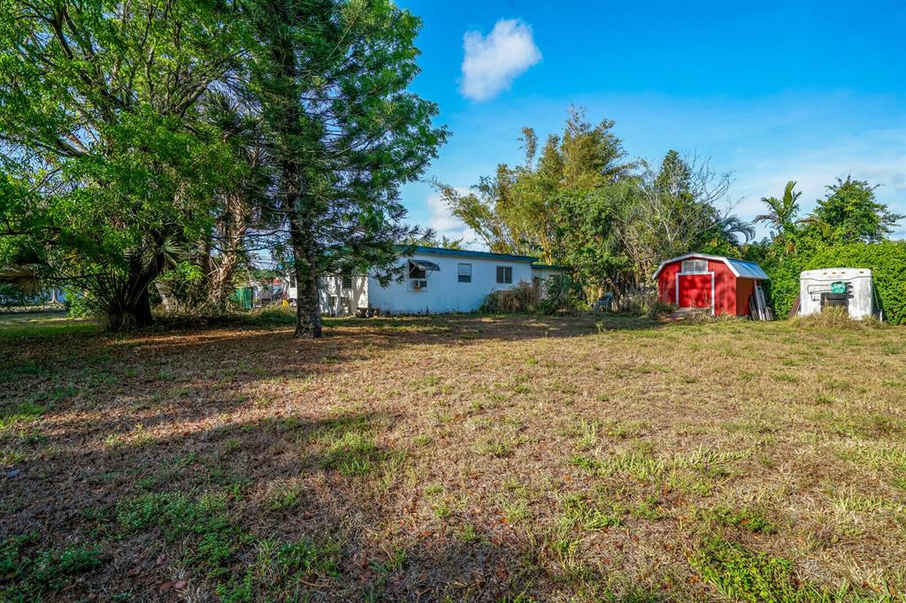 This one of a kind property is a must see! Single family home located on a .5 acre double lot that is zoned multifamily. Property is approved for 3 units w/potential for 5. units with assemblage. Home is 2 bedroom with 2 baths. Huge oversized garage that can easily store 4 cars. Sale includes adjacent vacant lot to the north on Preston Dr. Great location off Military Trail near Southern Blvd & Forest Hill Blvd. Easy access to both I-95, Turnpike, and main artery roads. Centrally located close to Downtown, shopping, local schools, beaches, and airport.