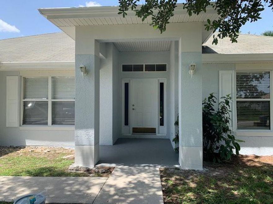 Spacious 4BR home situated on a lovely home site with mature landscaping overlooking a canal. This home has just been painted inside and out. Stunning New Luxury Rigid Core Wood laminate flooring in the entry hall,formal Living Room ,Formal Dining Room and Kitchen. In the kitchen you will find plenty of cabinets and loads of counter space.The Great Room features vaulted ceilings,upgraded ceramic tile & a french door that leads to the large covered patio overlooking the canal, where you can relax and be entertained by the beautiful Florida wildlife. This unique floor plan has 2 FULL en-suite baths  in the Master,one with a shower & one with a large garden tub, both have their own Walk-in Closets & Private water closets. The 4th bedroom w/double doors could also be a great office or den