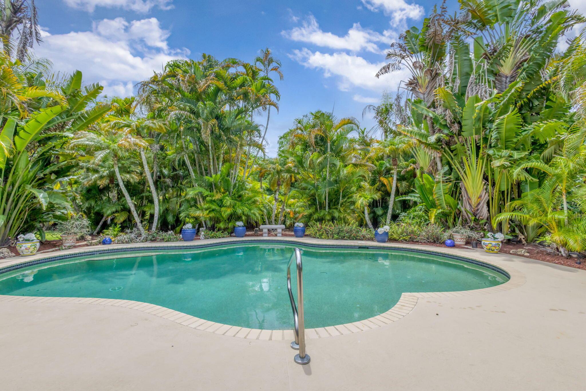 Welcome to this wonderful fully fenced landscape 1.15 acres single-family home in Palm Beach Country EstatesThis property offers four bedrooms and two baths and a separate garage with over 750 ft.. The great room overlooks the tropical pool area and has a beautiful fireplace. Once you're in the home, you will enjoy spacious family room for entertaining and a wonderful kitchen that accommodates the best of Cooking. The master bedroom has an extra large walk-in closet and a beautiful newly renovated shower. The fourth bedroom is being used as an office and two guest bedrooms is a split plan with privacy and their own guest bath. The extra long driveway gives you plenty of parking for RVs, boats, and extra guests visiting.