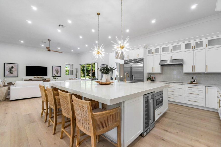 Introducing 5745 Native Dancer situated in Steeplechase, an exclusive gated, luxury community in Palm Beach Gardens where all homes are on at least an acre.Welcome to a magnificent, stunning light and bright south facing completely reimagined renovated property! This 5 bedroom plus office, 5 1/2 bathroom residence offers 4,452 square feet of living space all on one story on a sprawling 1.18-acre beautifully landscaped, private property. Every detail has been meticulously crafted to create an exquisite living experience that rivals a luxury resort. Step inside to discover an array of impressive features including, but not limited to, a brand new roof with a transferable warranty, new impact glass windows and doors, hurricane rated garage doors, gorgeous wide plank light oak wood floor