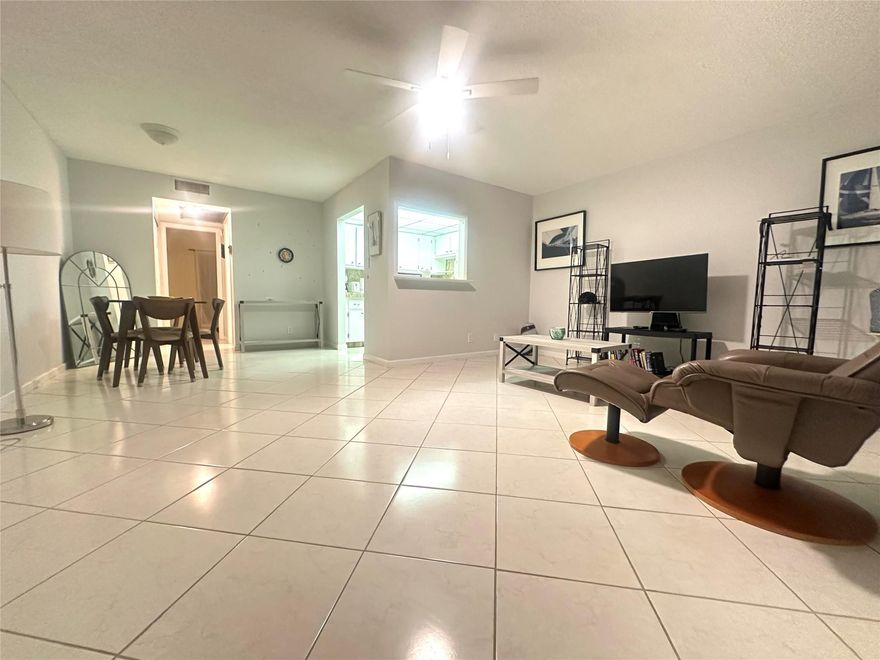 Welcome home to this clean & bright 1 bedroom, 1.5 bath condo located in the heart of Deerfield Bch.  Overlooking a peaceful garden view, this unit features white kitchen appliances & tile backsplash (no dome), ceramic tile thru-out, updated bathrooms w/shower stall & glass shower doors in primary & a lg enclosed patio w/sliding windows.  Conveniently located next to laundry & elevator. Financially secure bldg. w/comm BBQ picnic area for entertaining guests. Enjoy this active adult gated comm w/24 hr. sec, 16 pools, tennis, pickleball, shuffleboard, putting green, state-of-the-art Clubhouse w/fitness cntr, free movies, broadway shows, library, classes, clubs, indoor & outdoor pools. Close to dining, shopping & minutes to the beach! Don't miss this great opportunity!  Assoc. Claims 55+