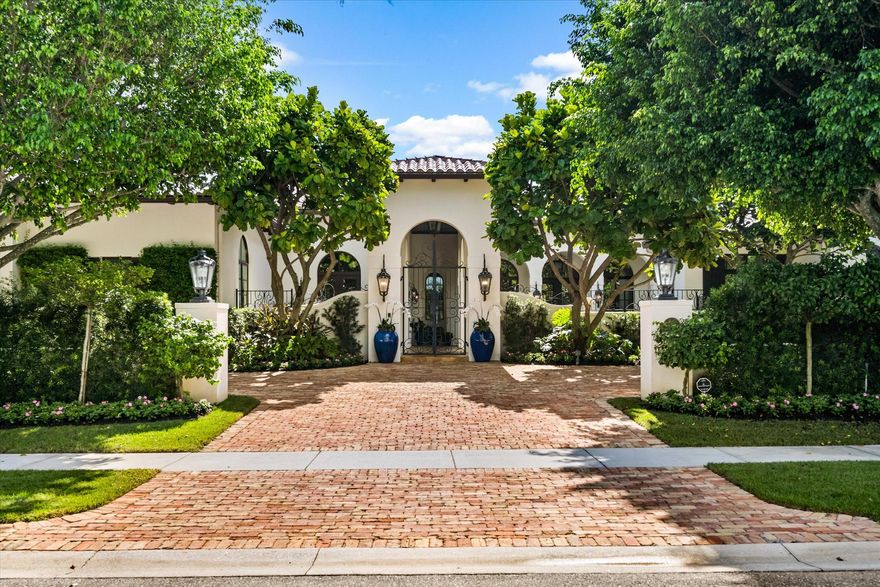 Exuding sophistication and timeless appeal, this stunning Cypress Island estate epitomizes luxury living within the prestigious Palm Beach Polo Golf and Country Club. Perfectly situated on a serene waterfront lot, the residence offers nearly 6,000 square feet of refined single-level living with 4 bedrooms, 6.5 bathrooms, and a 3-car garage.Sunlit interiors reveal a gourmet chef's kitchen appointed with Wolf appliances, a glass-enclosed walk-in wine cellar adjacent to the formal dining area, and an elegant living room anchored by a beautifully crafted fireplace. The owner's wing provides a private sanctuary featuring a sitting area, dual baths, and generous dressing spaces, while three spacious guest suites each include private baths and walk-in closets.