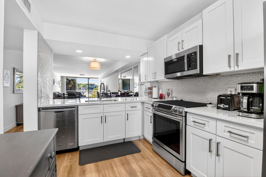 Spacious 3rd floor renovated and move in ready 2 bedroom, 2 bath condo overlooking the Whitehall community pool. Long balcony with 2 entrances, new HVAC, luxury vinyl plank flooring, neutral colors, modern, updated kitchen with white shaker style cabinets and stainless steel appliances. With 1437 sq ft of living space, there is an extra large dedicated laundry room, part of which can be used as extra storage or an office space. Central location, close to shopping, restaurants, I-95 and PBIA.