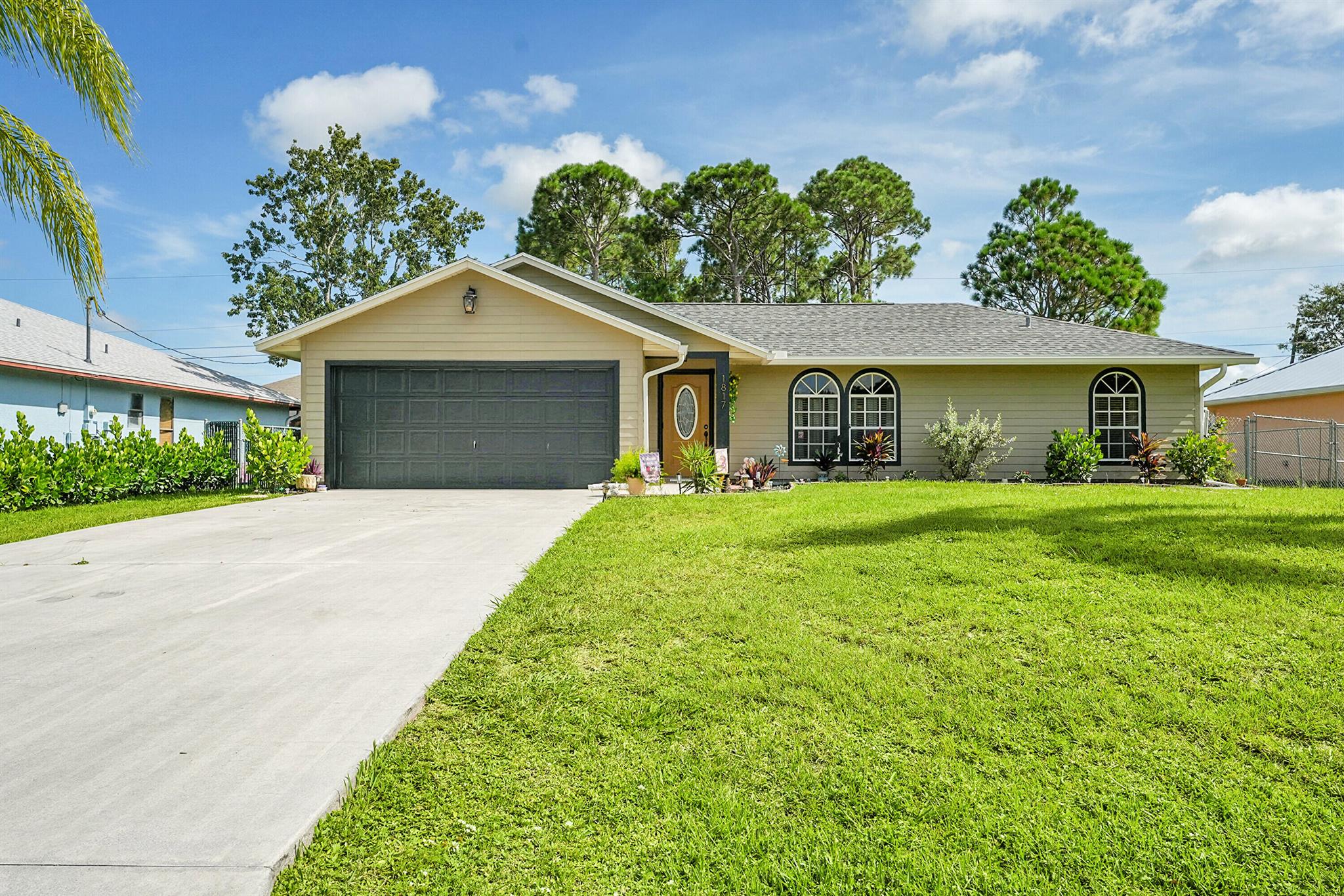 Nestled in the desirable Rosser Reserve area of Port St. Lucie, this beautifully upgraded 3-bedroom, 2-bath home blends modern comfort with everyday convenience located just minutes from I-95, shopping, schools, parks, and the thriving Tradition area. From the moment you arrive, the curb appeal speaks for itself. A freshly painted exterior trim adds a crisp, polished look, while mature landscaping, lush green lawn, and a full hedge of vibrant Clusias offer privacy and a sense of tropical serenity. Inside, you're welcomed by fresh interior paint and a bright, open layout that flows seamlessly into a thoughtfully updated kitchen. A stacked stone backsplash, Corian countertops, and newer stainless steel appliances make this kitchen both stylish and functional.