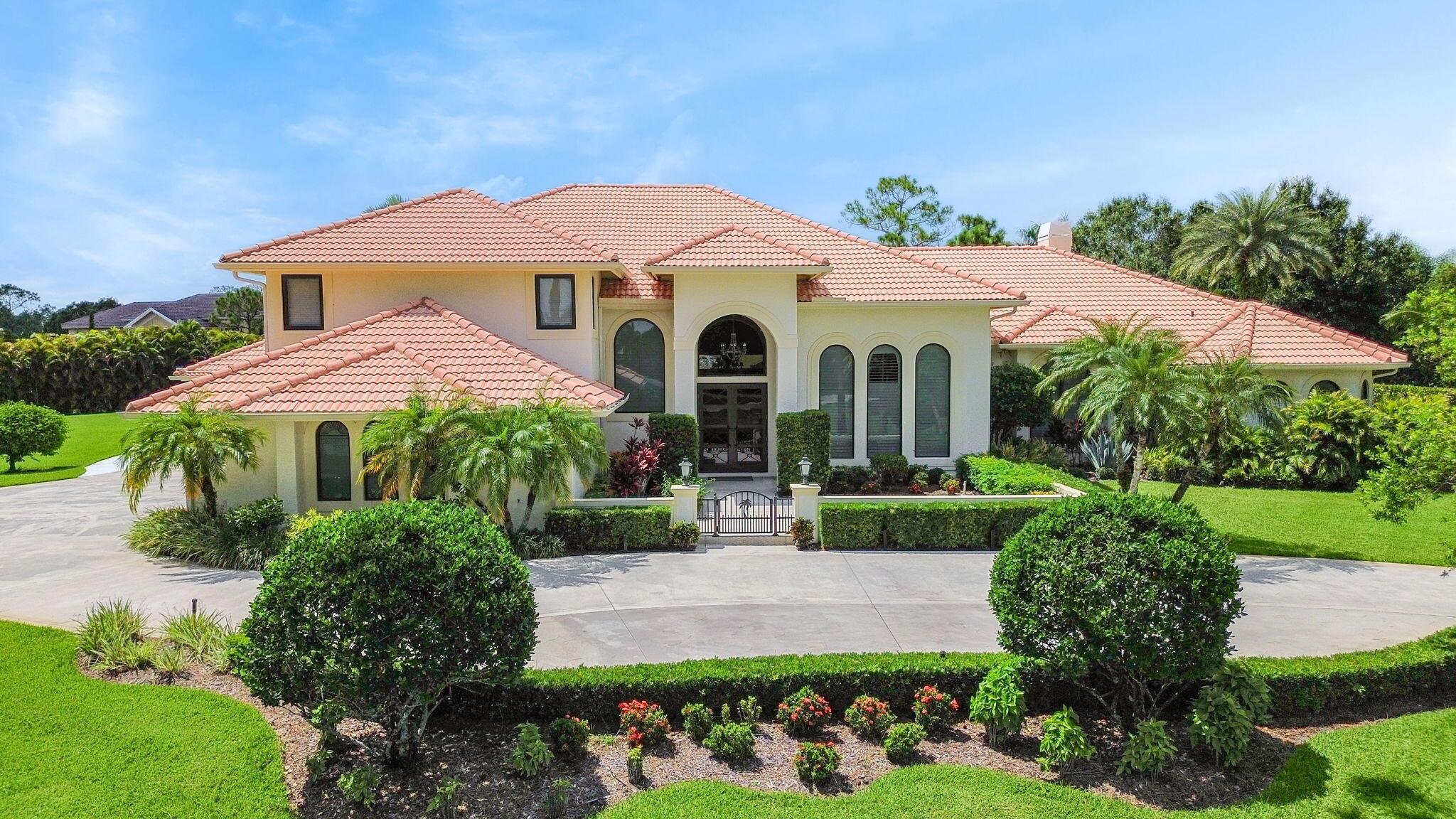 Estate home located in the prestigious community of PGA Village. Found in the Sabal Creek subdivision, this 2 story Mediterranean is situated on 1.7 acres. Property has a main house and an attached guest house, 3 car garage and large circular drive. Entire residence impeccably finished. French Cut Crema Marfil Marble flooring throughout, custom trim, crown molding, plantation shutters, 4000 SF main living quarters consist of 5BD and 3BA. Dramatic 2 story formal living room. Large dining room. Family room opens to a true chef's kitchen. State of the art appliances, custom cabinetry and a 6'x12' granite island. Adjoining Guest house complete with full kitchen, living room, 2BD and full BA. Large Screened Pool area with Tiki bar and covered Loggia. Grand home. Premier community. Paradise.