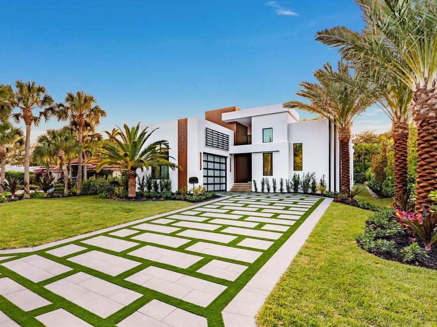 Hypoluxo Island | Brand-New One-Story Modern Estate

A rare opportunity to own the only newly constructed one-story modern residence currently available on prestigious Hypoluxo Island. Thoughtfully designed to capture the essence of contemporary Palm Beach living, this architectural showpiece blends clean modern lines with warm natural finishes and seamless indoor-outdoor flow. A dramatic 12-foot solid mahogany pivot hinge door opens to a grand gallery entry framed by soaring 16-foot ceilings and expansive walls of glass. Oversized 12-foot sliding doors flood the home with natural light and open completely to the outdoor living areas, creating a true resort-style environment.

The residence offers 3 bedrooms, 3 full bathrooms, a powder bath, and an additional full Pool bath serving the pool area. The primary suite is a private retreat featuring a spa-inspired bath complete with an in-home sauna, custom European built-in closets with integrated lighting, and refined modern finishes.

At the center of the home, a stunning backlit Cristallo quartzite island anchors the chef's kitchen, complemented by mitered Taj Mahal quartzite countertops, custom cabinetry, and a full suite of Thermador and Miele appliances. The adjacent outdoor entertaining area features a fully equipped summer kitchen finished in quartzite and a dedicated pool bath for effortless indoor-outdoor living.

The home showcases museum-level detailing throughout, including shadow-gap flush baseboards and casing, trimless recessed lighting, linear air diffusers, nine-foot solid interior doors, and large-format tile flooring. Impact glass windows and doors provide both security and energy efficiency, while full smart-home automation controls lighting, climate, audio, and security systems.

The private backyard is designed as a resort retreat, highlighted by a custom pool with water features and sun shelf surrounded by luxurious professionally designed landscaping creating a private resort-like setting. Additional features include smart toilets, tankless water heating, and a two-zone Platinum Series HVAC system.

Located minutes from beaches, dining, and the Palm Beach coastal lifestyle, this property offers new construction quality and modern design rarely found on Hypoluxo Island -- a truly exceptional offering.